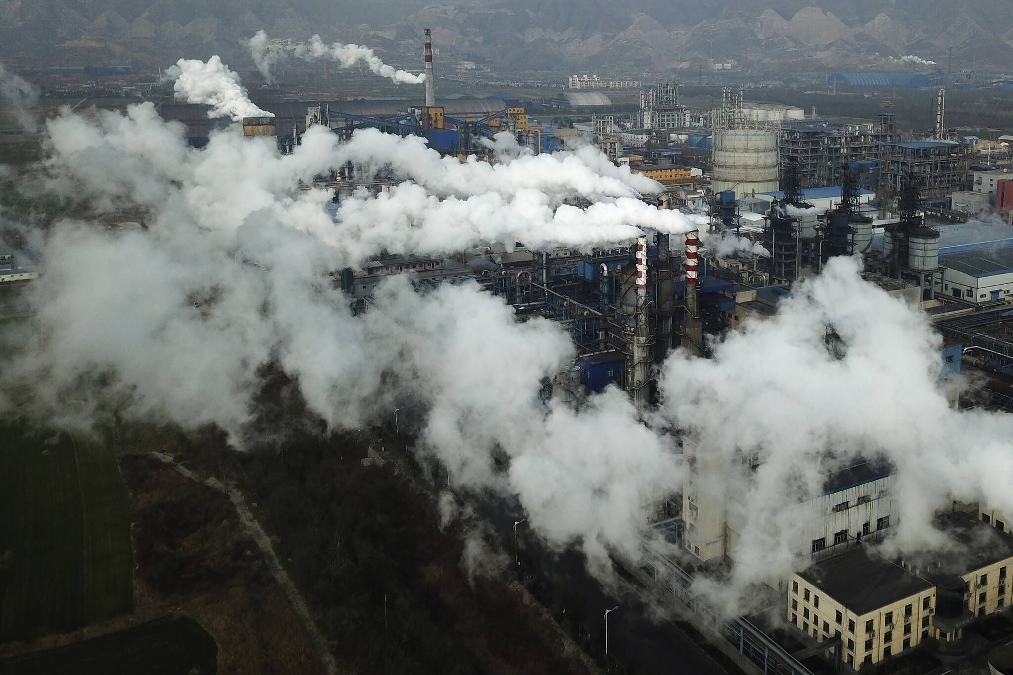 Smoke and steam rise from a coal processing plant in Hejin in central China’s Shanxi Province on Nov. 28, 2019. A study released on Tuesday, May 17, 2022, blames pollution of all types for 9 million deaths a year globally, with the death toll attributed to dirty air from cars, trucks and industry rising 55% since 2000. (AP Photo / Sam McNeil File)