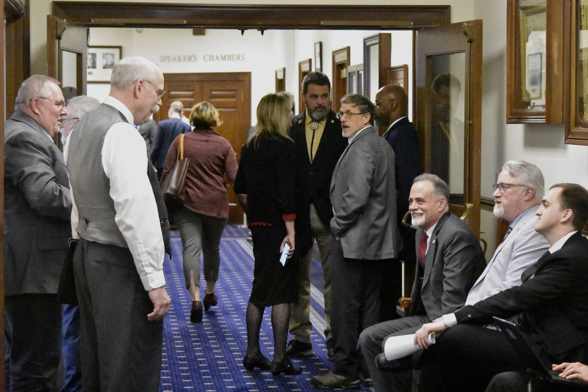 Lawmakers from both bodies of the Alaska State Legislature mingle in the halls of the Alaska State Capitol on Wednesday, May 18, 2022, the last day of the legislative session, following the Senate’s passing of the state’s budget bill. (Peter Segall / Juneau Empire)