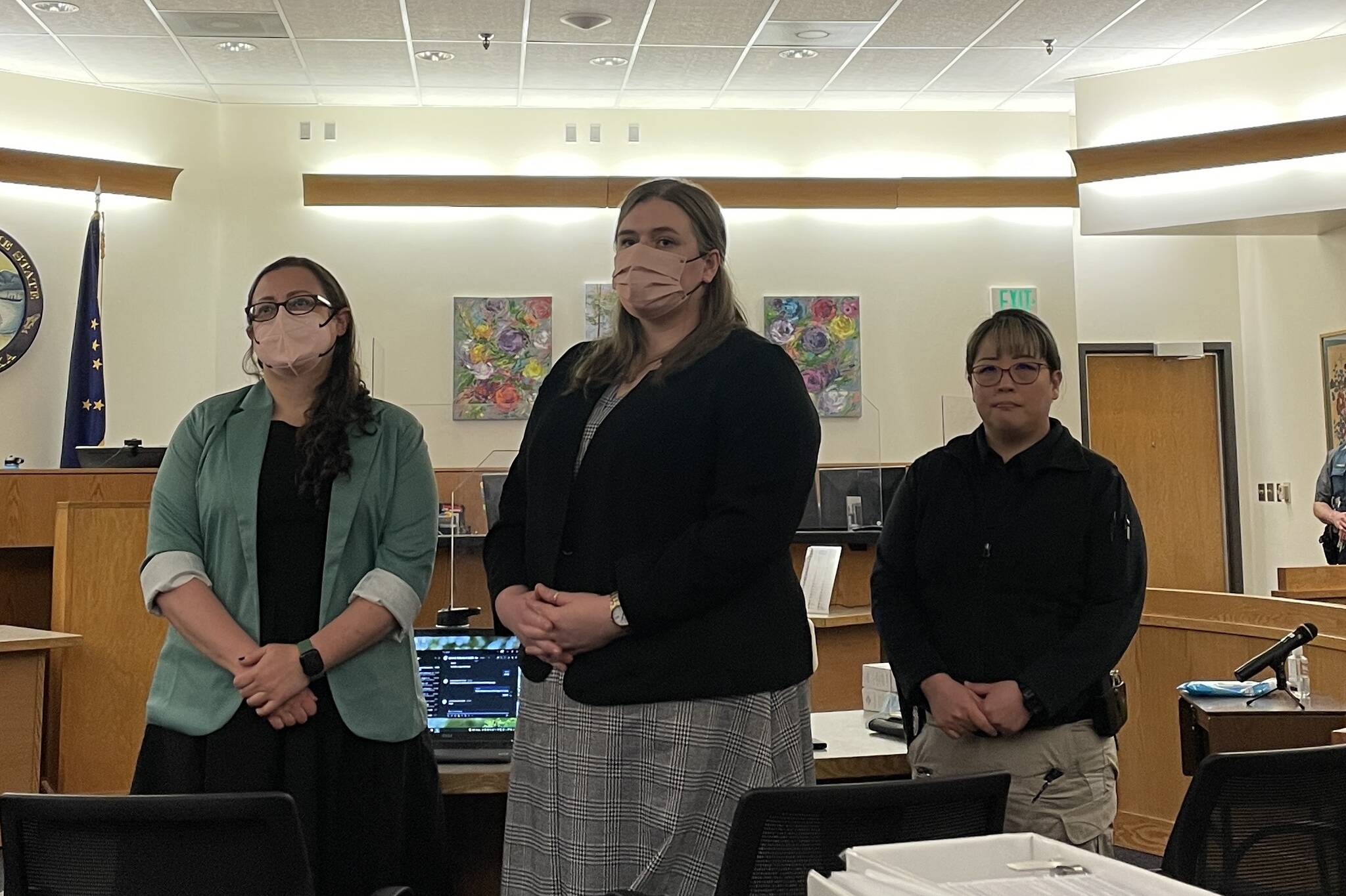 From the left, prosecutors Jessalyn Gillum, Katherine Lybrand and Detective Kathy Underwood stand as the jury for the trial of a fatal 2019 stabbing enter the courtroom. (Michael S. Lockett / Juneau Empire)