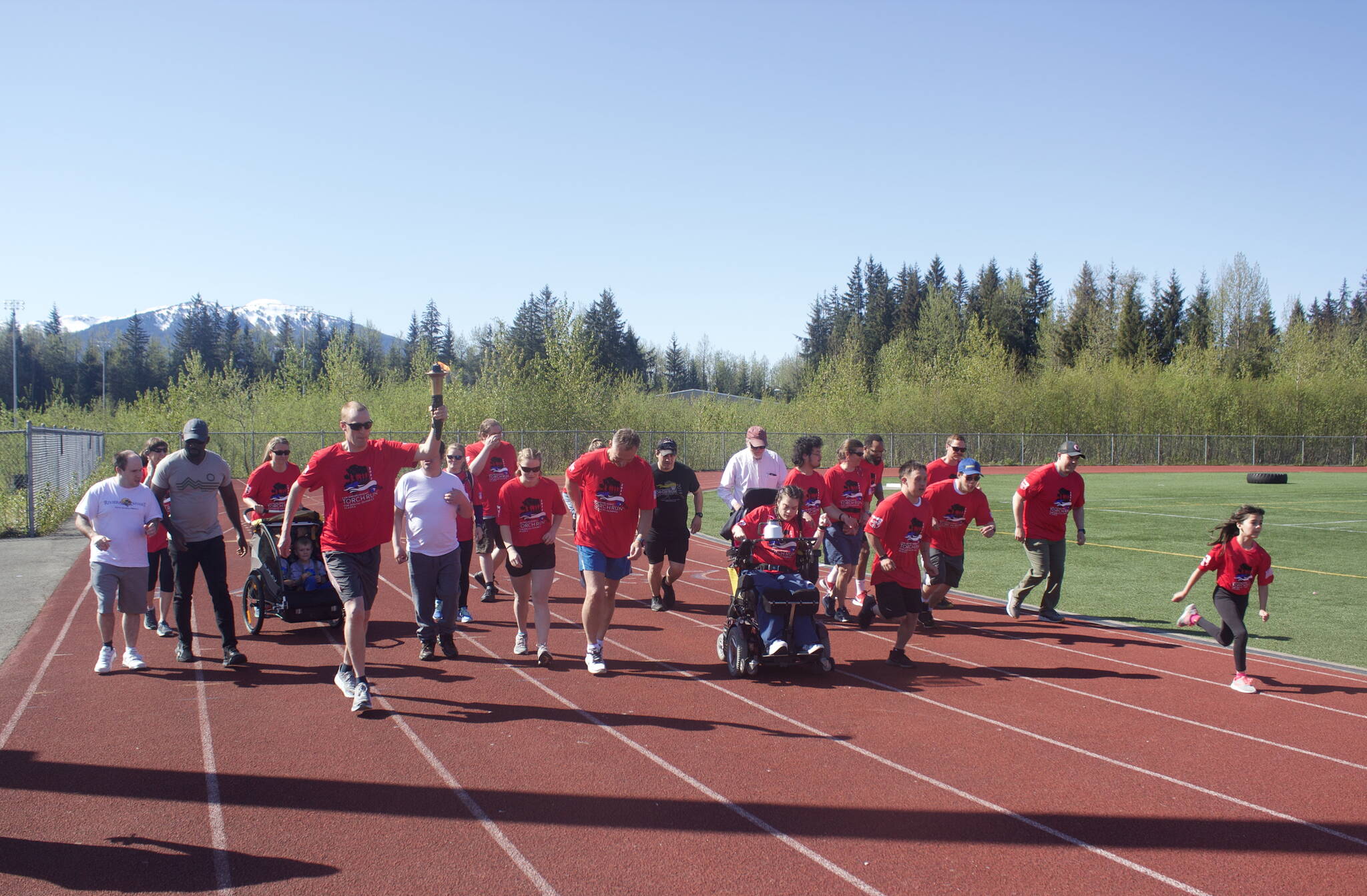 About 30 participants dash out from the starting line at the Alaska Law Enforcement Torch Run at Thunder Mountain High School on Saturday morning. Participants opted for either a two-mile or 5K course, including a start and finish lap around the school’s track. (Mark Sabbatini / Juneau)