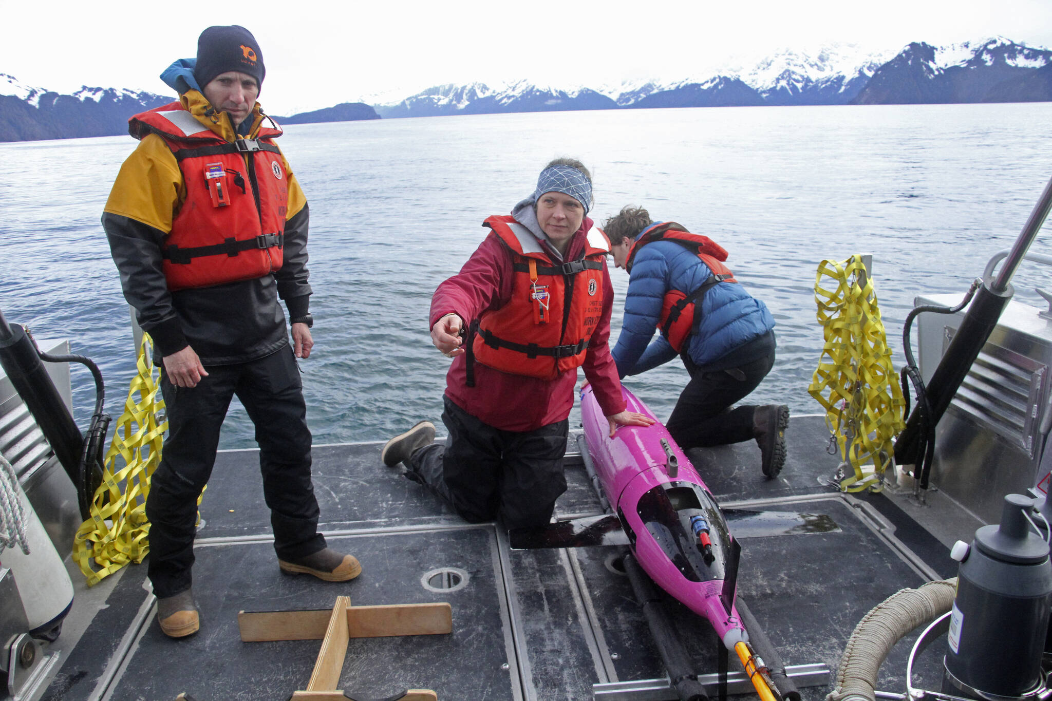 This May 4, 2022, photo shows oceanographers Andrew McDonnell, left, and Claudine Hauri, middle, along with engineer Joran Kemme after an underwater glider was pulled aboard the University of Alaska Fairbanks research vessel Nanuq from the Gulf of Alaska. The glider was fitted with special sensors to study ocean acidification. (AP Photo / Mark Thiessen)