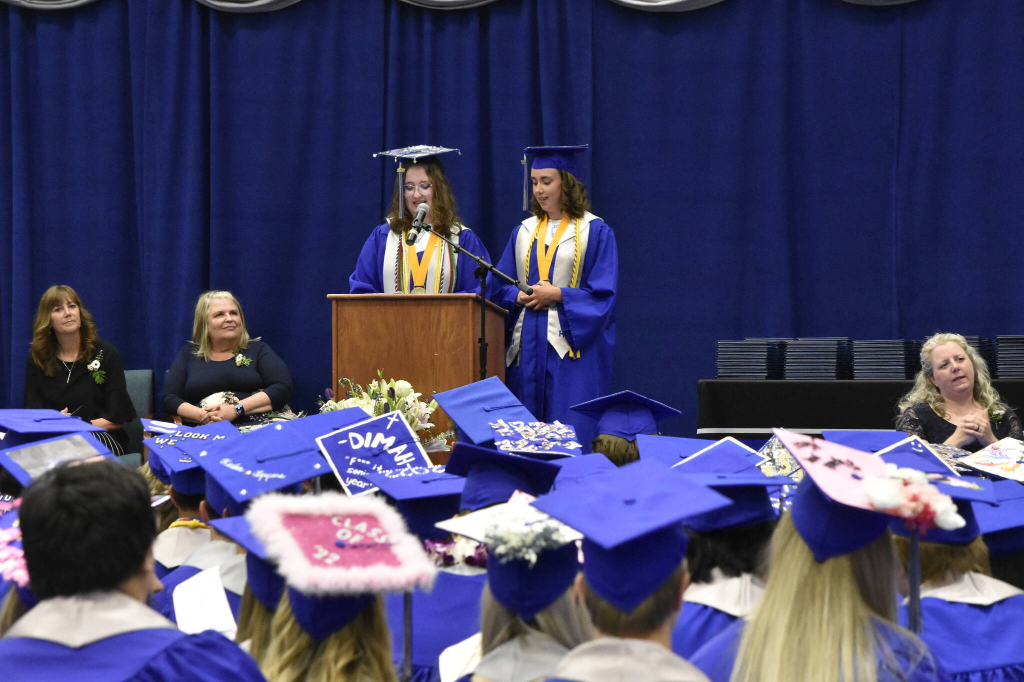 Thunder Mountain High School valedictorians Devin Moorehead, left, and Grace Sikes, deliver remarks to the class of 2022 graduation ceremony on Sunday, May 29, 2022. (Peter Segall / Juneau Empire)