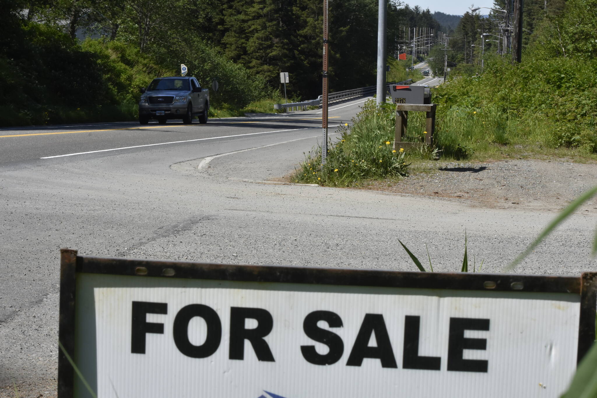 A sign on the Douglas Highway advertises a home for sale on Thursday, June 2, 2022. Home prices in Alaska have been increasing for the past two years but an expected increase to interest rates might cool off the market. (Peter Segall / Juneau Empire)
