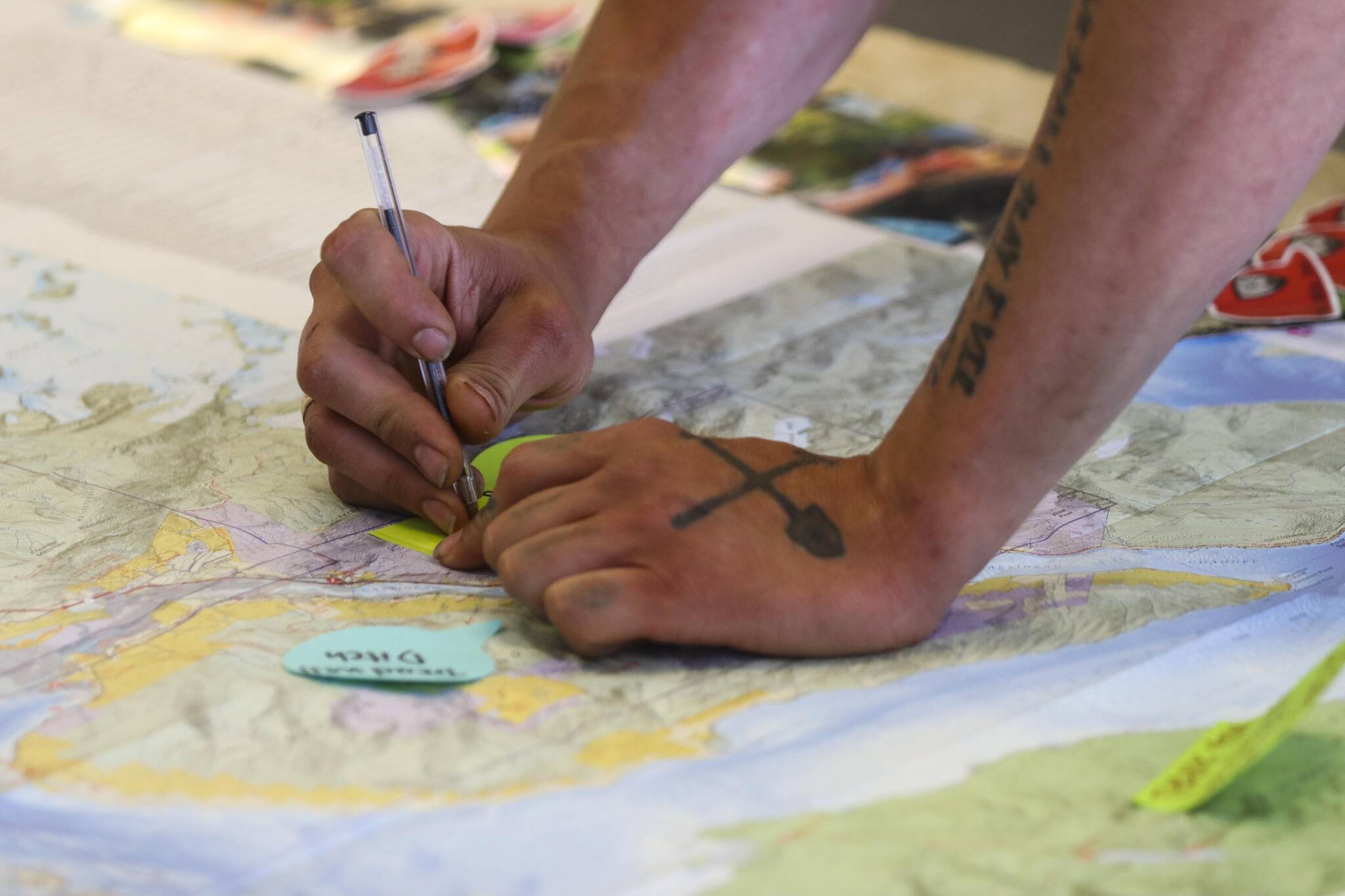 Trail Mix Inc’s project manager Duncan Campbell makes a notation on a map at the nonprofit’s new office during their National Trails Day event on June 4, 2022 (Michael S. Lockett / Juneau Empire)