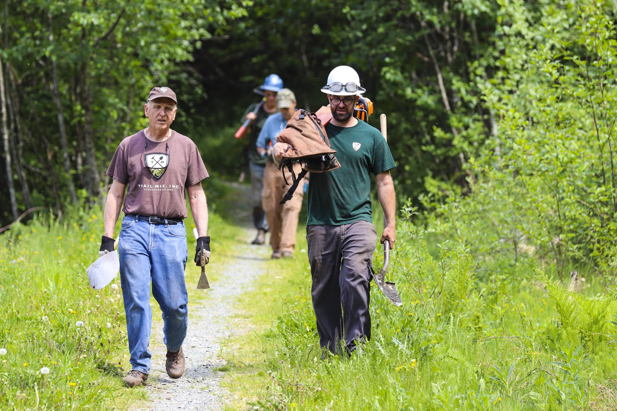 Trail Mix Inc.’s executive director, Ryan O’Shaughnessy, right, walks with Mike McKrill off Lemon Creek Trail on June 4, 2022 after taking part in the organization’s annual National Trails Day event. (Michael S. Lockett / Juneau Empire)