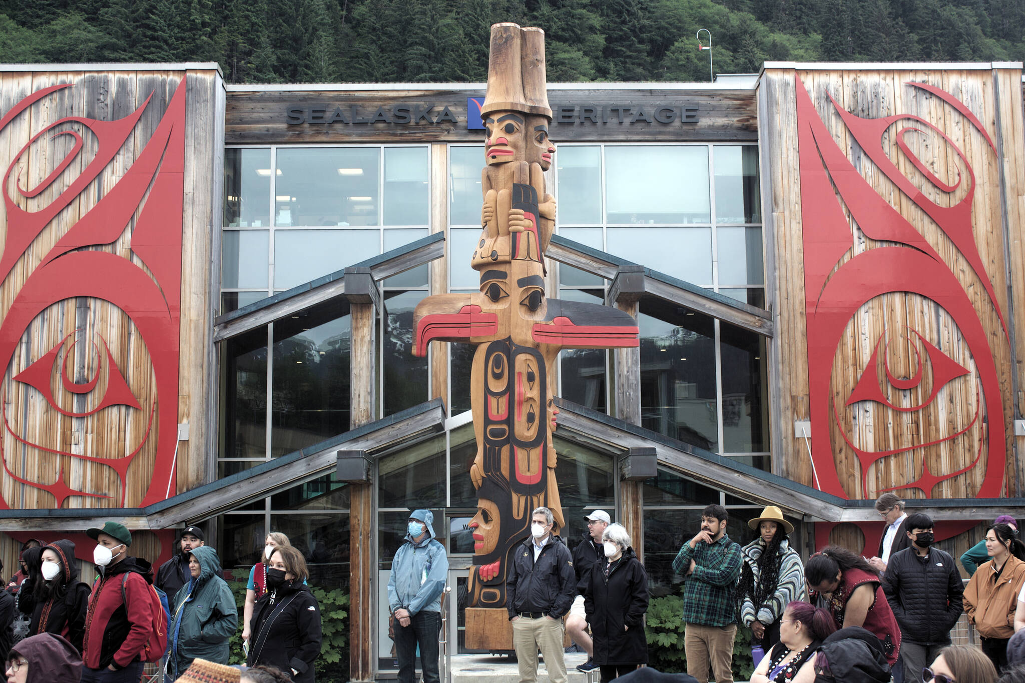 A 22-foot-high totem pole made from a 600-year-old red cedar tree receives its official welcoming during the debut of the Sealaska Heritage Arts Campus on Wednesday. The totem was crafted during a nine-month period by master carver TJ Young (Sgwaayaans) and his brother Joe (Gidaawaan). (Mark Sabbatini / Juneau Empire)