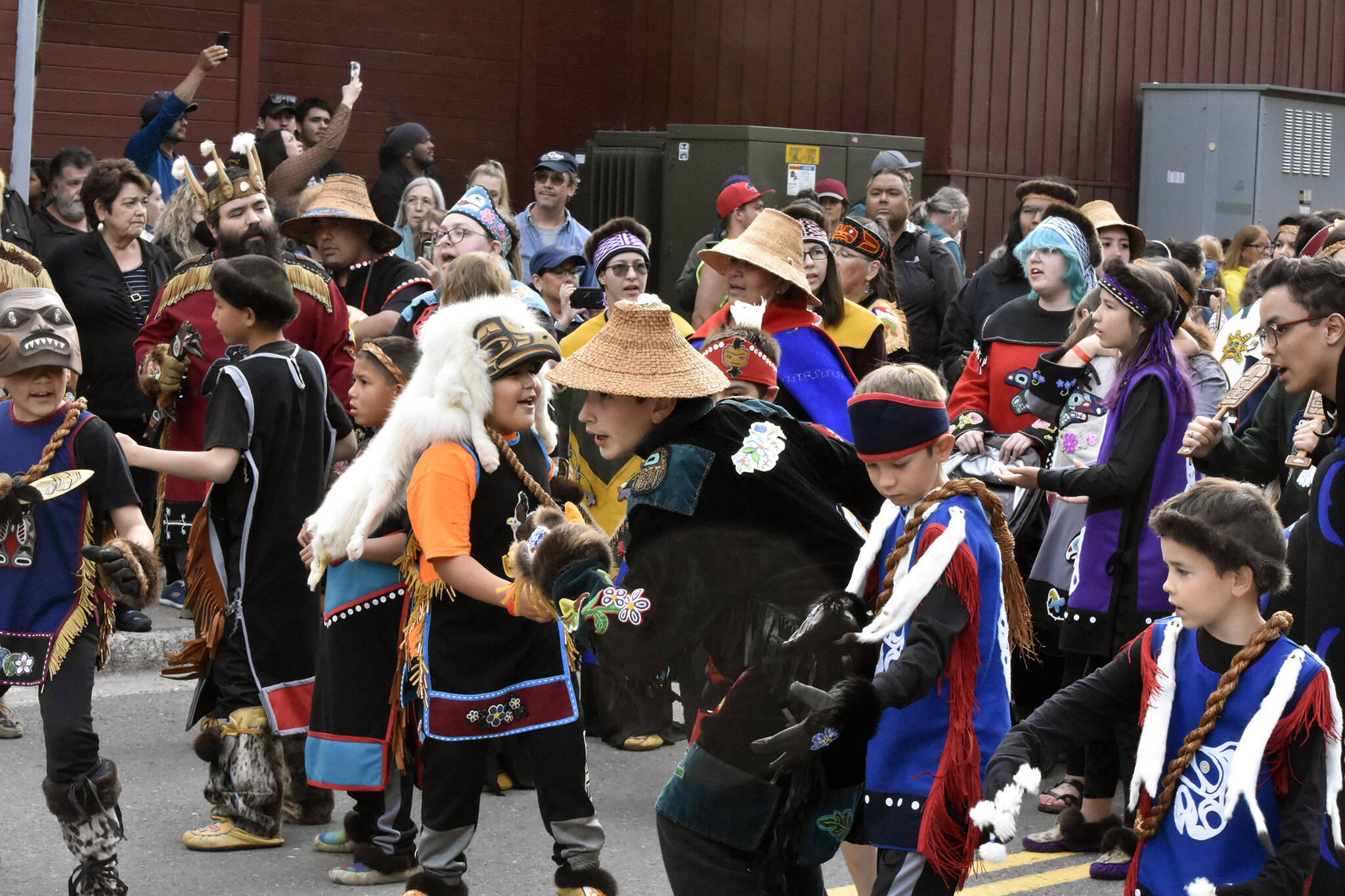 Dozens of dance groups were lined up on Willoughby Avenue on Wednesday, June 8, 2022, getting ready for the grand procession through Centennial Hall for Celebration 2022. Many groups were dancing and singing well before they entered the hall. (Peter Segall / Juneau Empire)
