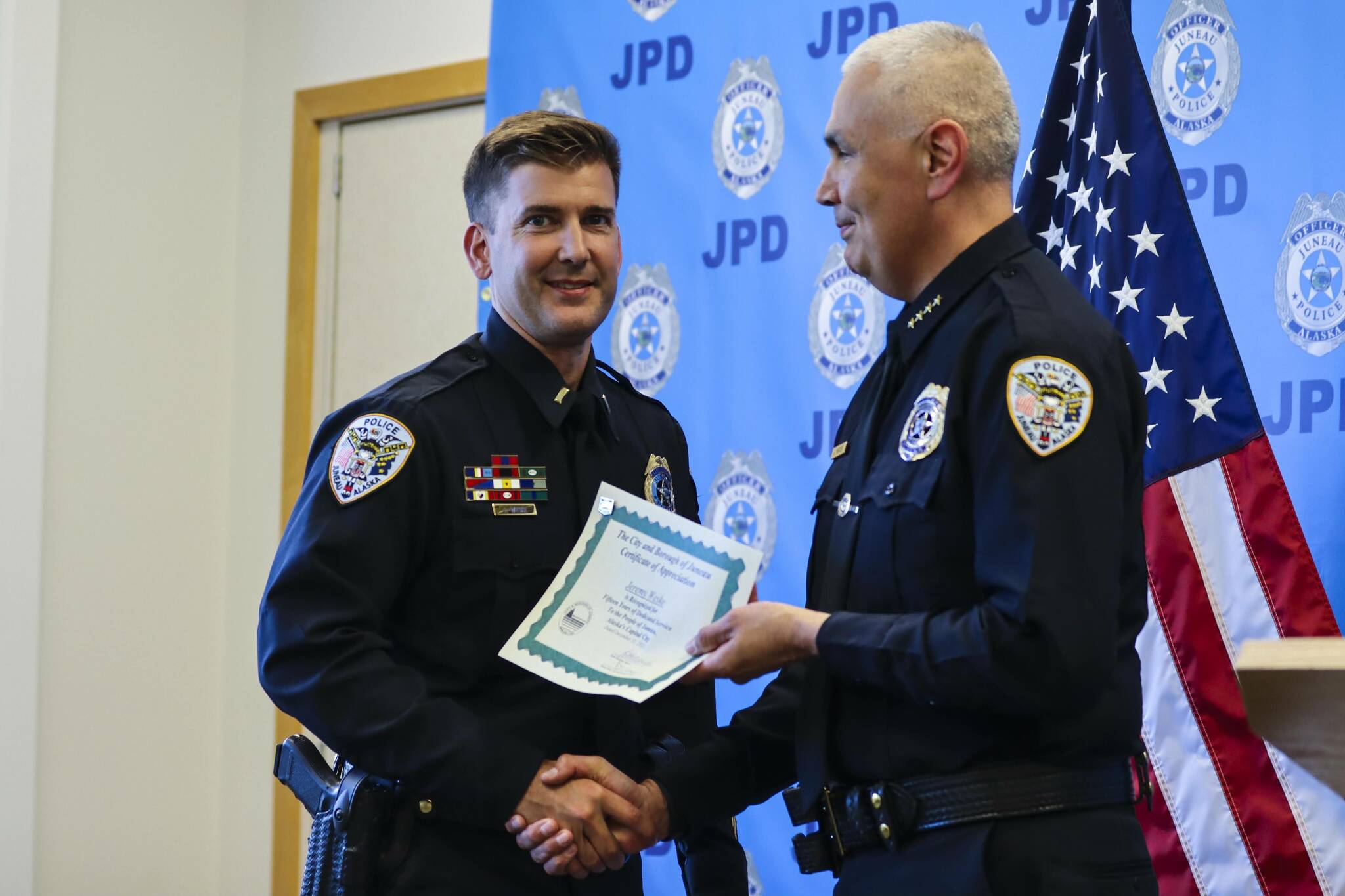 Michael S. Lockett / Juneau Empire 
Chief Ed Mercer presents Lt. Jeremy Weske with a certificate for his 15 years of service during the Juneau Police Department’s annual award ceremony on June 9, 2022.