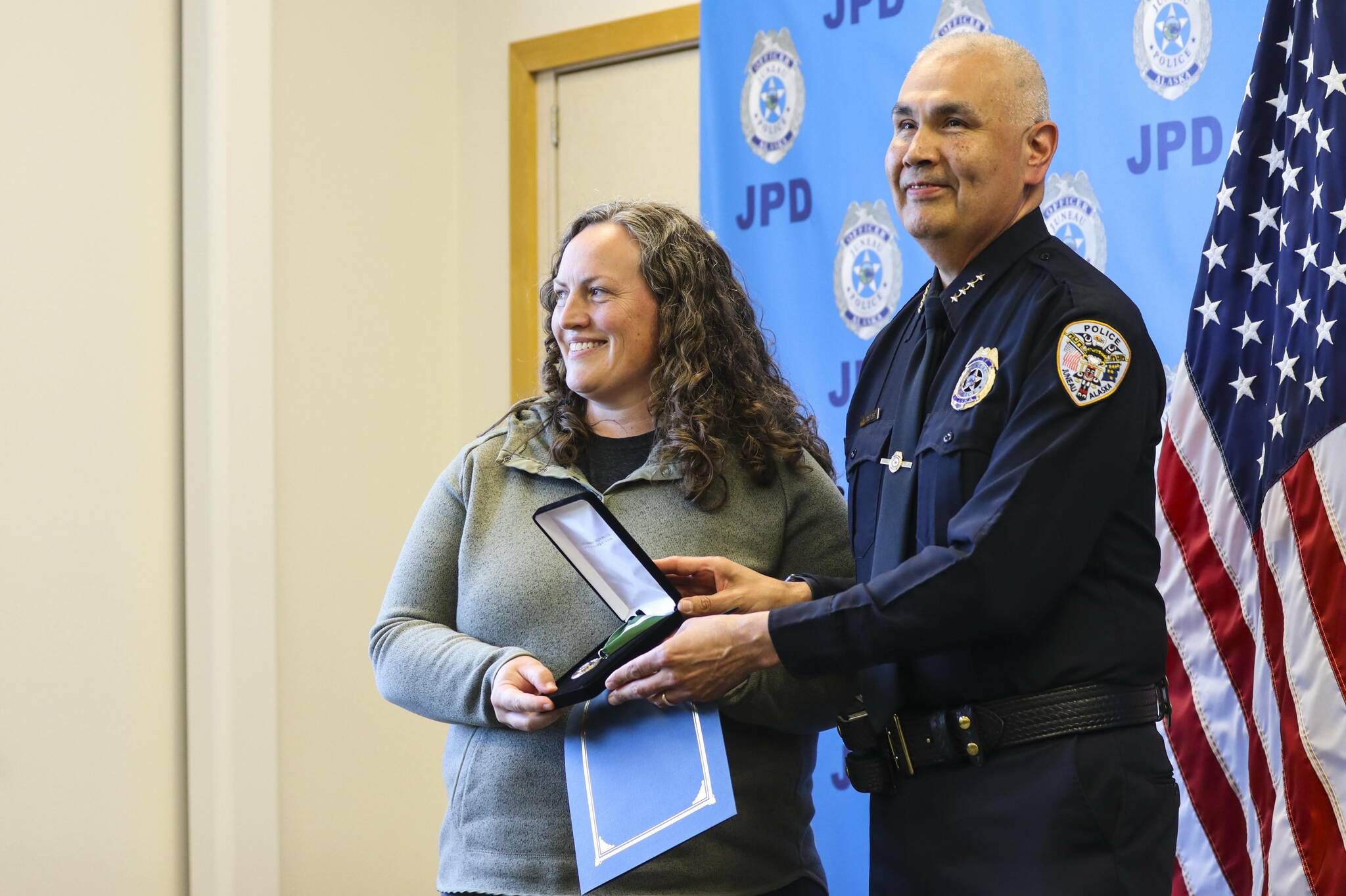 Chief Ed Mercer presents community service officer Sarah Dolan with the Jackie Renninger Community Policing Award during the Juneau Police Department’s annual award ceremony on June 9, 2022. (Michael S. Lockett / Juneau Empire)
