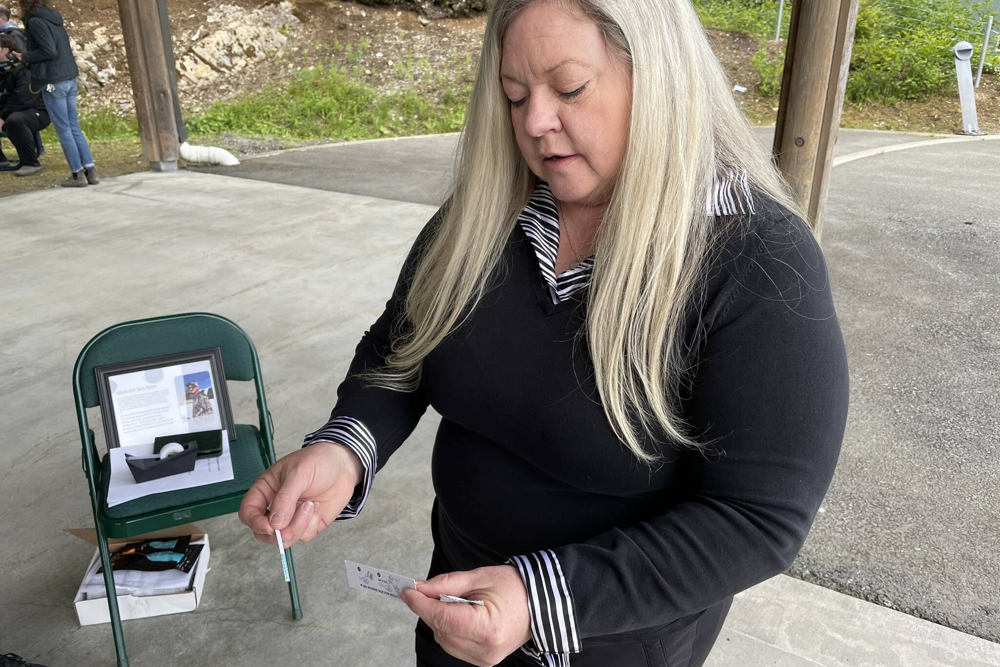Denise Ewing, mother of Gabe Johnston, whose death galvanized the creation of Project Gabe, demonstrates a fentanyl test strip on June 10, 2022. Volunteers assembled 150 opioid overdose kits for the project. (Michael S. Lockett / Juneau Empire)