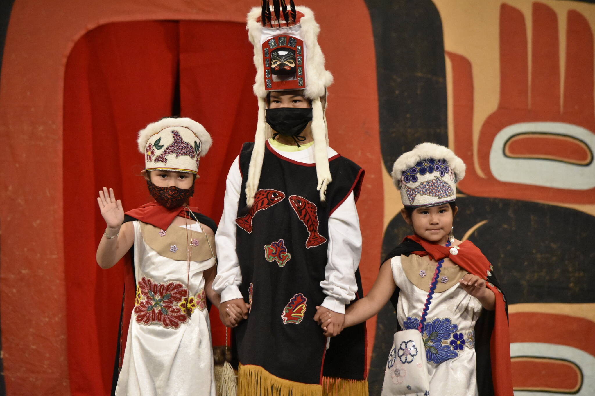 From left to right, Saige Jack, with cousins Zayn and Blake Johnson, show off their regalia - a mix of Tlingit and Athabascan pieces - during the Toddler Regalia Review at Centennial Hall on Friday, June 10, 2022. (Peter Segall / Juneau Empire)