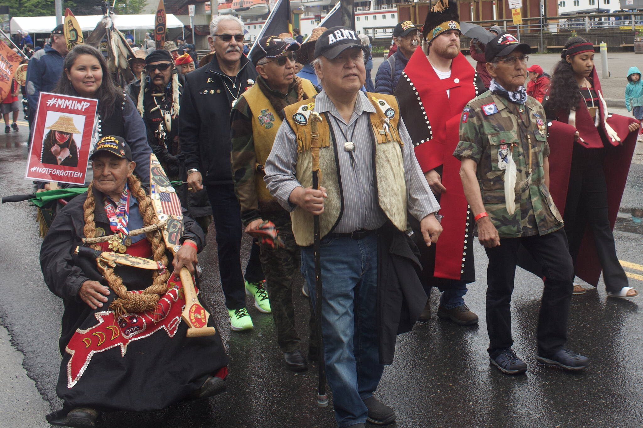 Alaska Native veterans pass by gift shops next to Marine Park during the Celebration parade Saturday. (Mark Sabbatini / Juneau Empire)