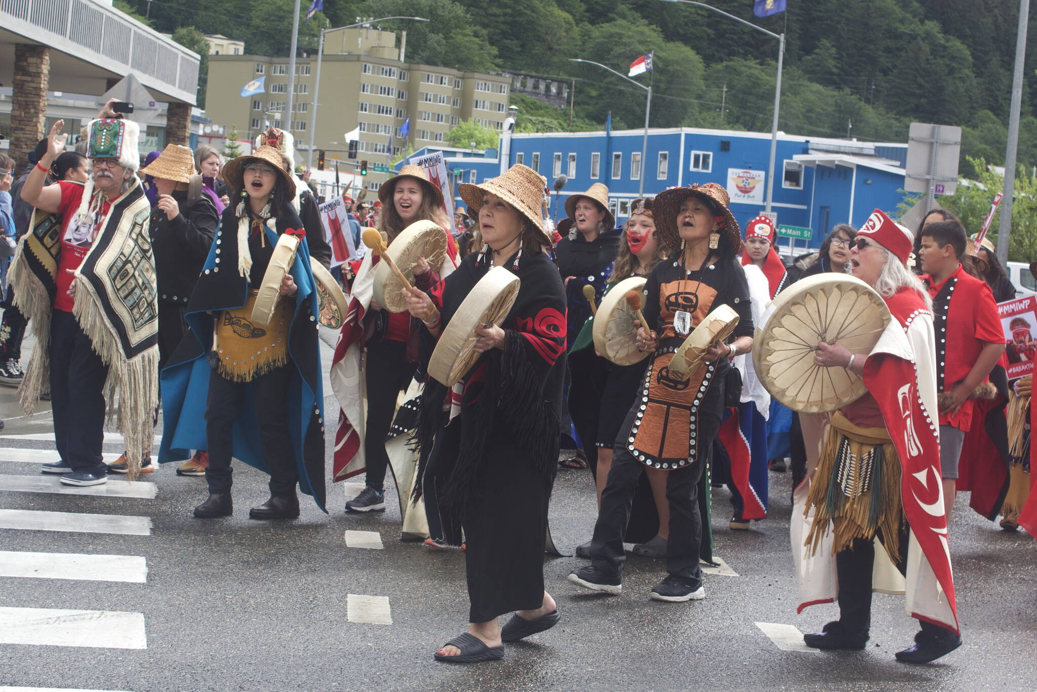 A group of women drummers nears the end of the Celebration parade route at the turnoff to Centennial Hall on Saturday. The four-day Alaska Native gathering is marking its final day with events at the hall including an afternoon of dances, a screening a film commemorating Celebration’s 40-year anniversary and the Grand Exit. (Mark Sabbatini / Juneau Empire)