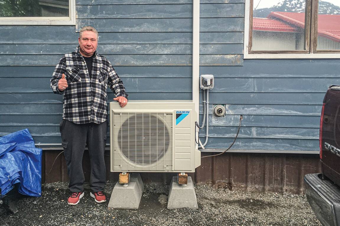 Local group Alaska Heat Smart has received $2 million in federal grant money and will be using the funds to provide energy upgrades to low-income homes. In this May 2020 photo, Raymond Lindoff poses with his air source heat pump, installed by Renewable Juneau in 2020. (Courtesy photo / Andy Romanoff)