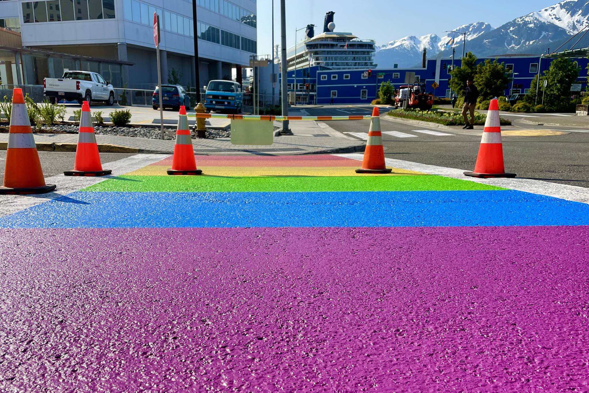 Paint dries Thursday morning on Juneau’s rainbow crosswalk as the colorful crossing gets its annual repainting on June 16, 2022. (Michael S. Lockett / Juneau Empire)