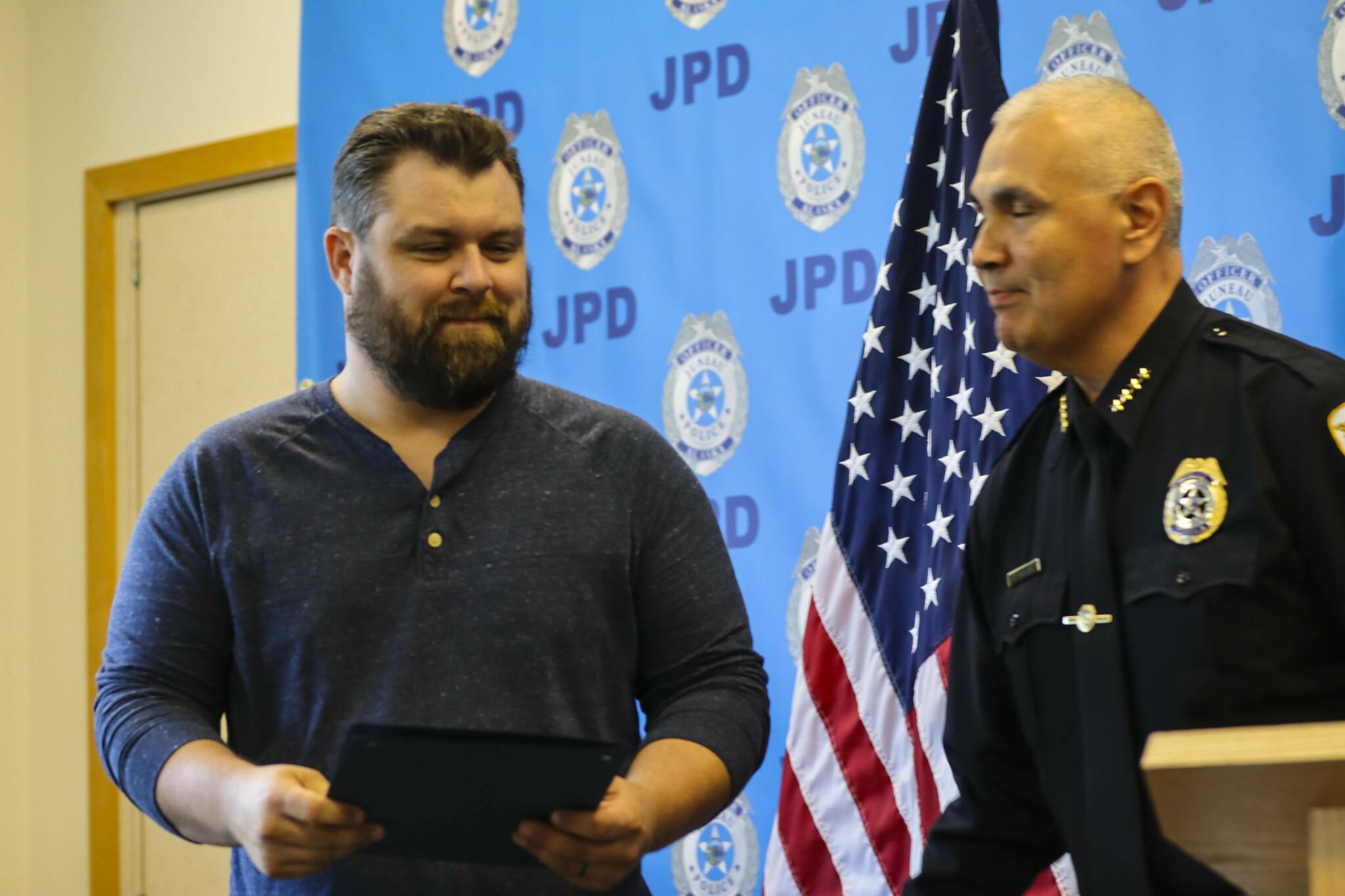 Chief Ed Mercer presents Robert Partin an award for bravery during the Juneau Police Department’s annual award ceremony on June 9, 2022. (Michael S. Lockett / Juneau Empire)