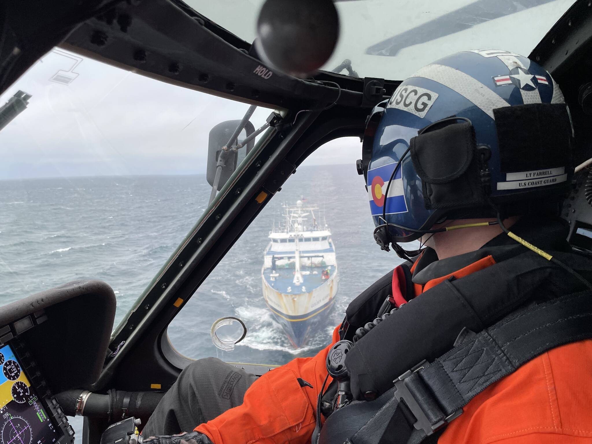 Coast Guard Lt. Zachary Farrell is shown flying an MH-60 Jayhawk helicopter during the medical evacuation of a mariner near Cold Bay, Alaska, on June 14, 2022. (Lt. Cmdr. Scott Filipowicz / U.S. Coast Guard)