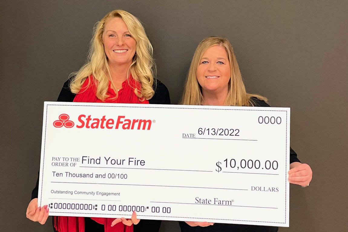 Melissa McCormick, left, accepts a check from State Farm insurance agent Robin Lonas for the Find Your Fire nonprofit as part of a State Farm outreach program. (Courtesy photo / State Farm)