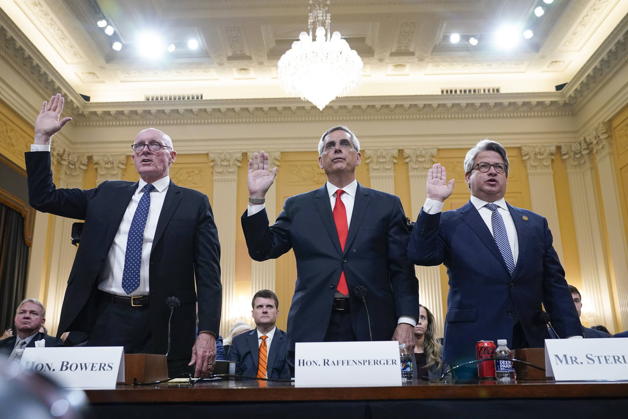 Rusty Bowers, Arizona state House Speaker, from left, Brad Raffensperger, Georgia Secretary of State, and Gabe Sterling, Georgia Deputy Secretary of State, are sworn in to testify as the House select committee investigating the Jan. 6 attack on the U.S. Capitol continues to reveal its findings of a year-long investigation, at the Capitol in Washington, Tuesday, June 21, 2022. (AP Photo/Jacquelyn Martin)