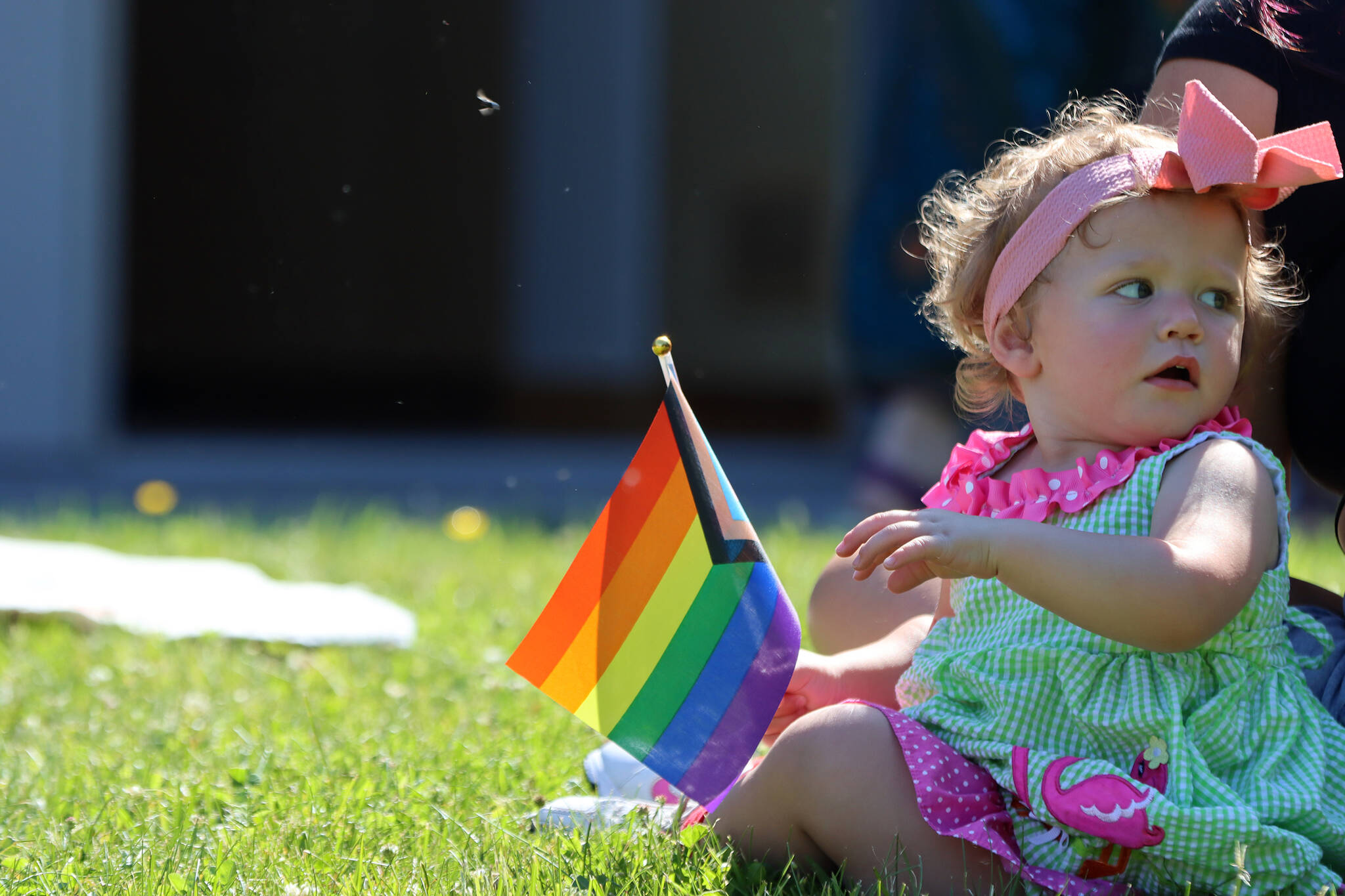 Aires Kelley, 1, holds a Pride flag Saturday during Drag Storytime at the Mendenhall Valley Public Libary. (Ben Hohenstatt / Juneau Empire)
