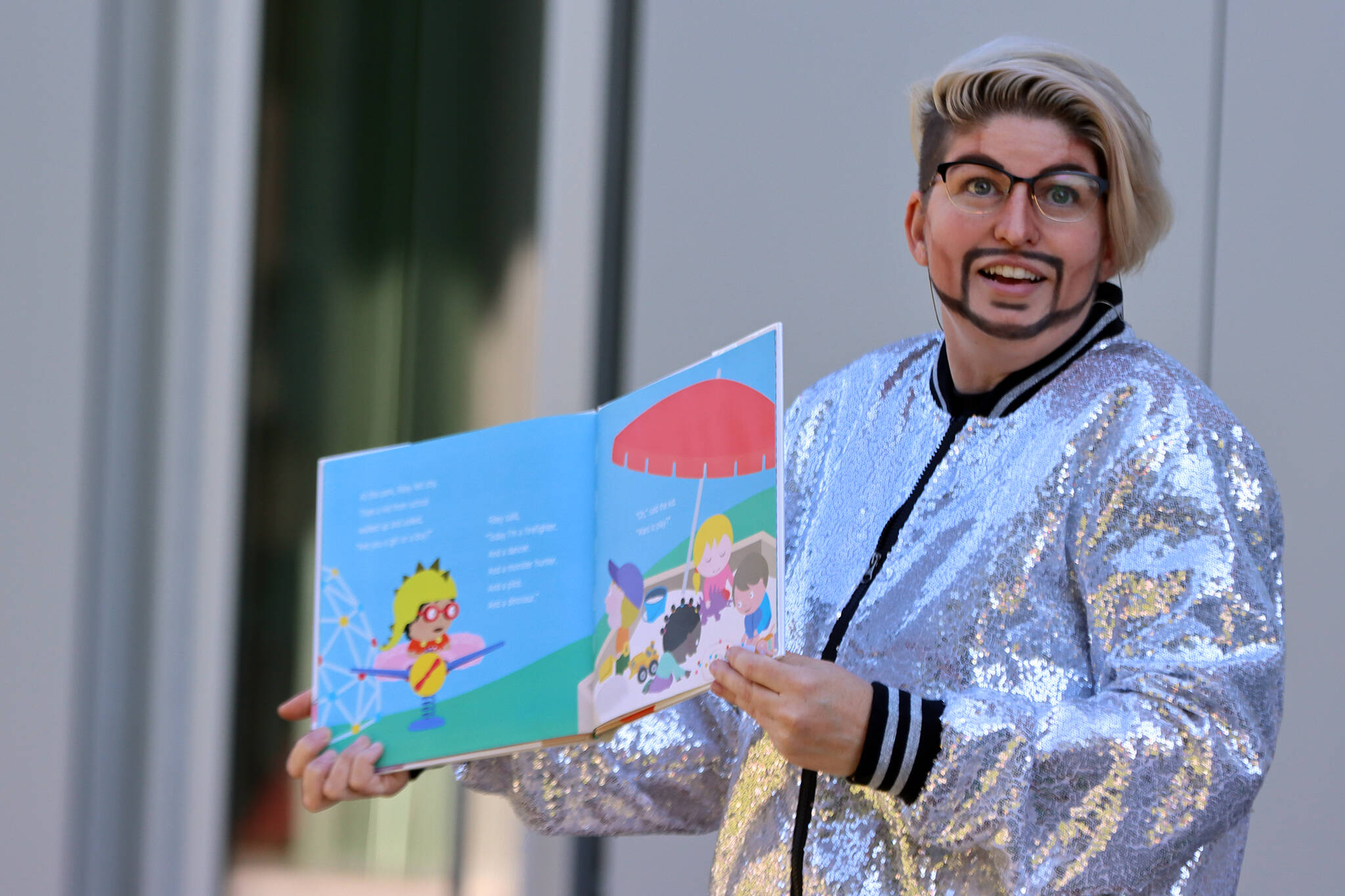Drag king Max Stout reads a book to families during Drag Storytime at the Mendenhall Valley Public Library.(Ben Hohenstatt / Juneau Empire)