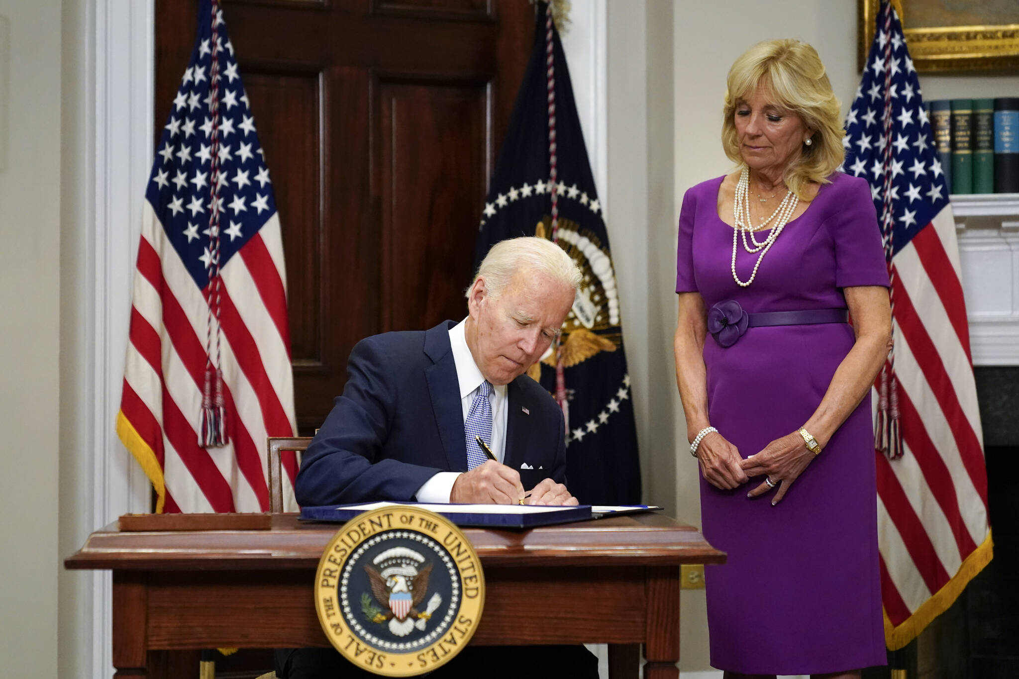 President Joe Biden signs into law S. 2938, the Bipartisan Safer Communities Act gun safety bill, in the Roosevelt Room of the White House in Washington, Saturday, June 25, 2022. First lady Jill Biden looks on at right. (AP Photo / Pablo Martinez Monsivais)