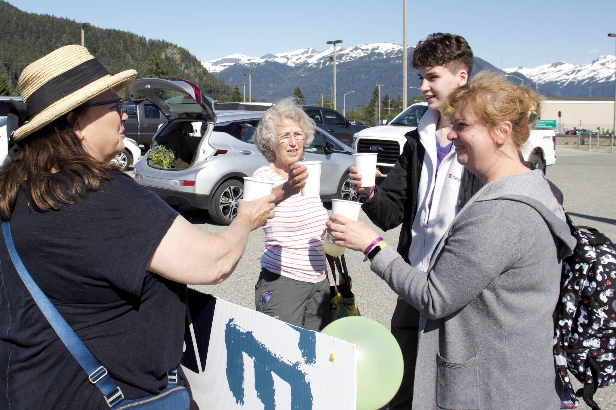 Mark Sabbatini / Juneau Empire 
Iryna Hrynchenko and her 18 year old son, Ivan Hrynchenko, 18, Joyanne Bloom and Bridget Smith toast to the Ukrainians’ arrival Saturday at Juneau International Airport. Bloom and Smith are part of a five-person group of residents who raised funds to bring the Hrynchenkos to Juneau, and is helping them with housing, education and job opportunities, and in other ways.