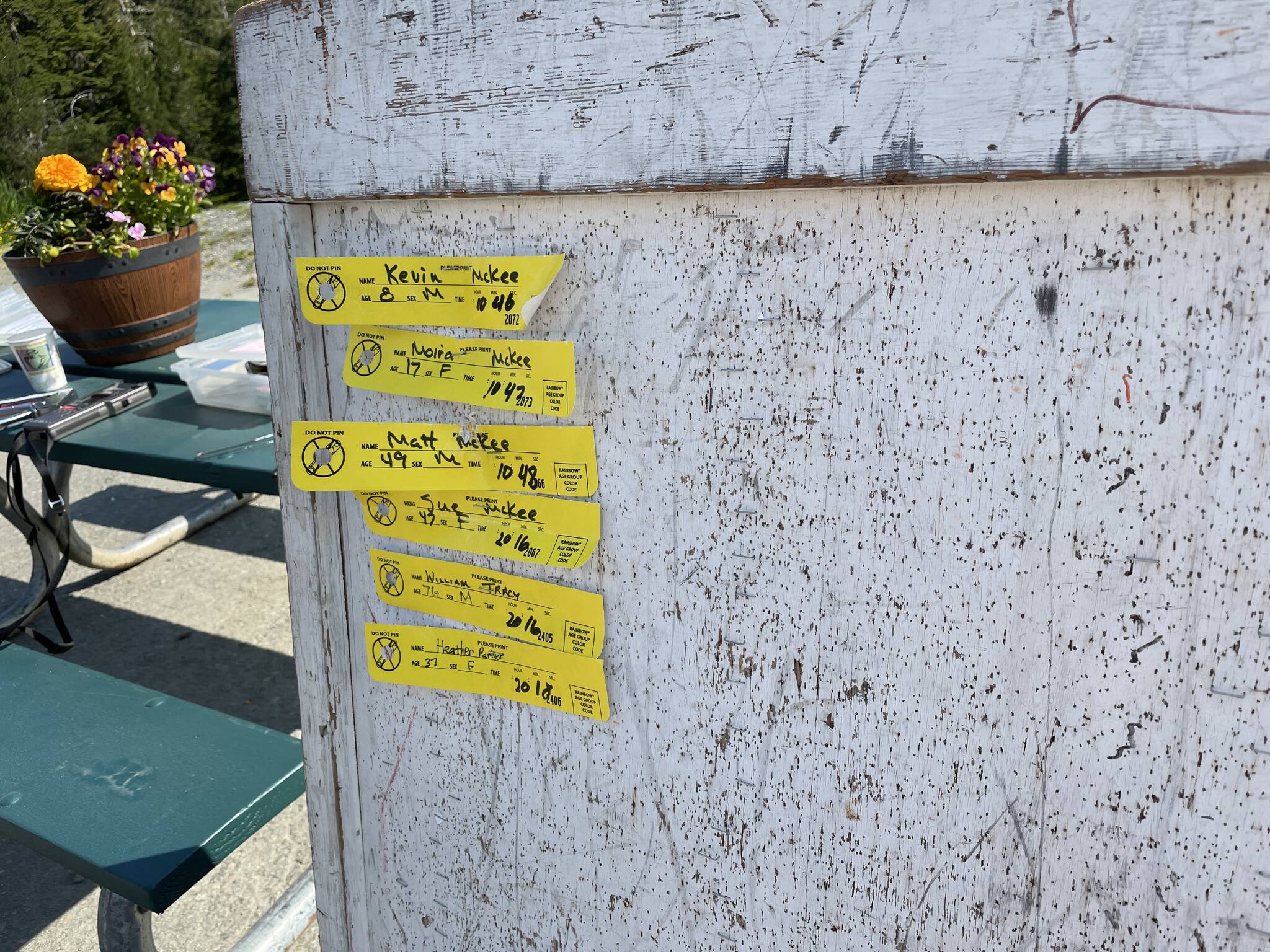 One-miler finisher tags adorn the board for the Eaglecrest Road and Ridge Race on July 2, 2022. (Michael S. Lockett / Juneau Empire)