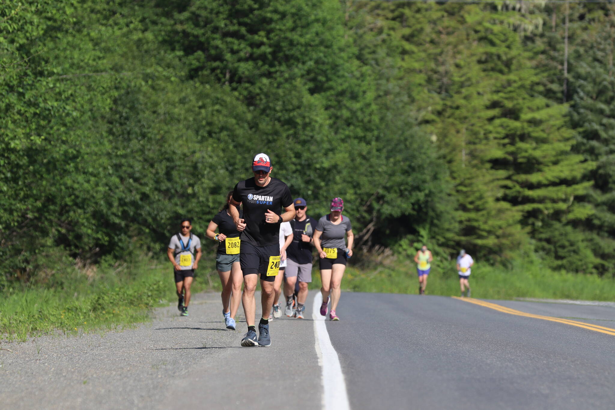 Runners pound up Fish Creek Road towards the ski area during the Eaglecrest Road and Ridge Race on July 2, 2022. (Michael S. Lockett / Juneau Empire)