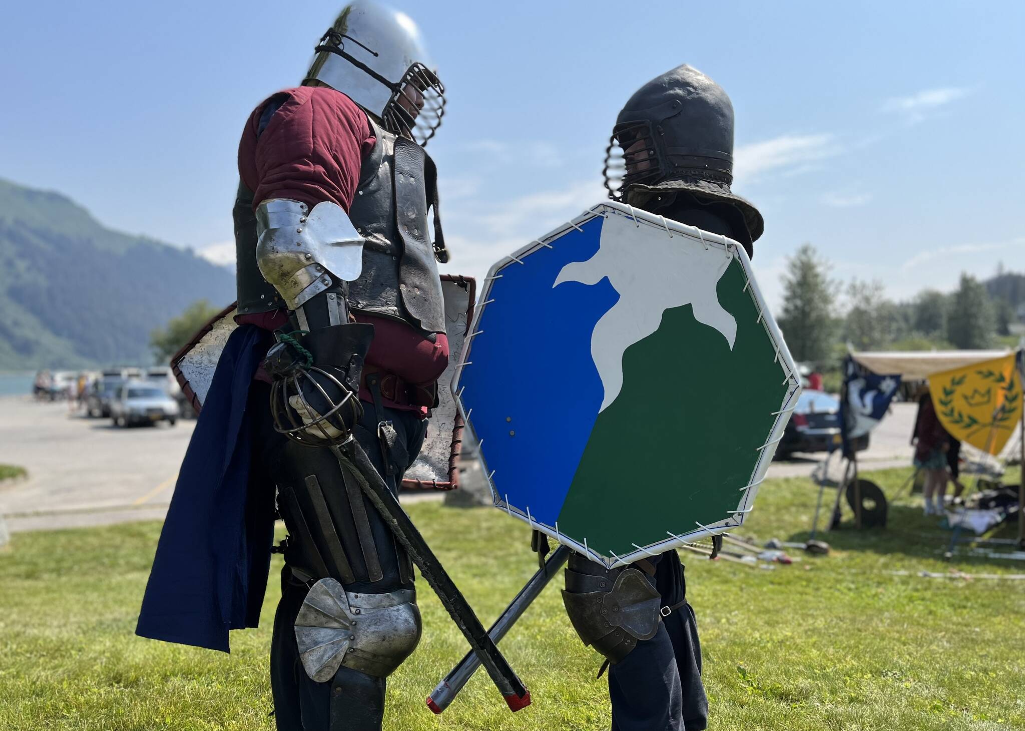 Hill Lewis, aka Rolland, instructs beginner knight David Caldwell, aka Aiden Hawk, on the finer points of SCA combat during Douglas Fourth of July festivities.(Jonson Kuhn / Juneau Empire)