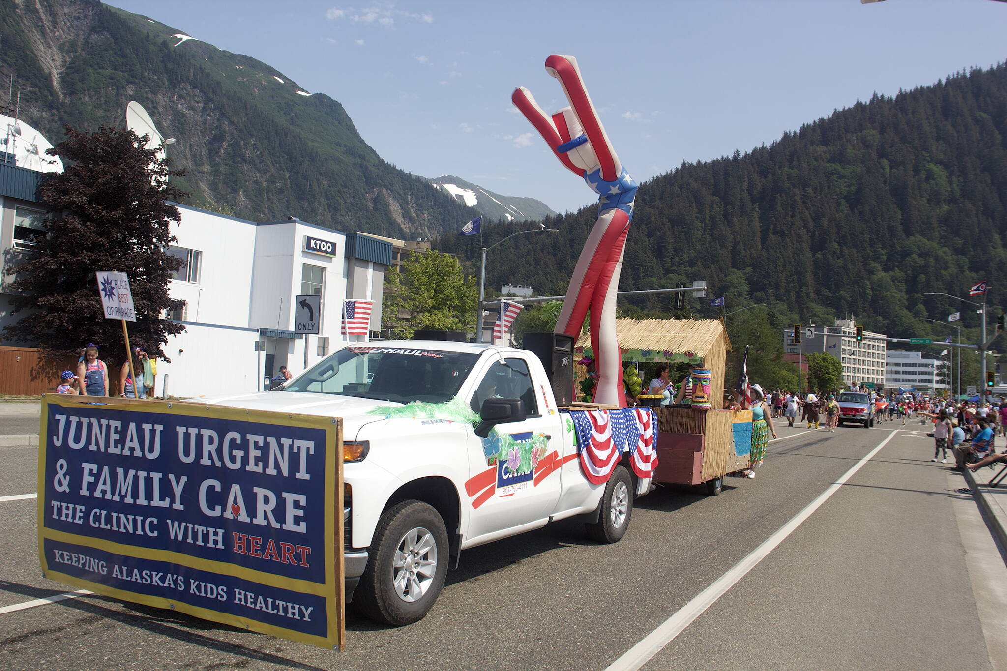 A towering inflatable Uncle Sam “waves” to the crowd from the Hawaiian-themed Juneau Urgent Care float that was won the Best of Parade award in this year’s downtown July 4 parade. (Mark Sabbatini / Juneau Empire)