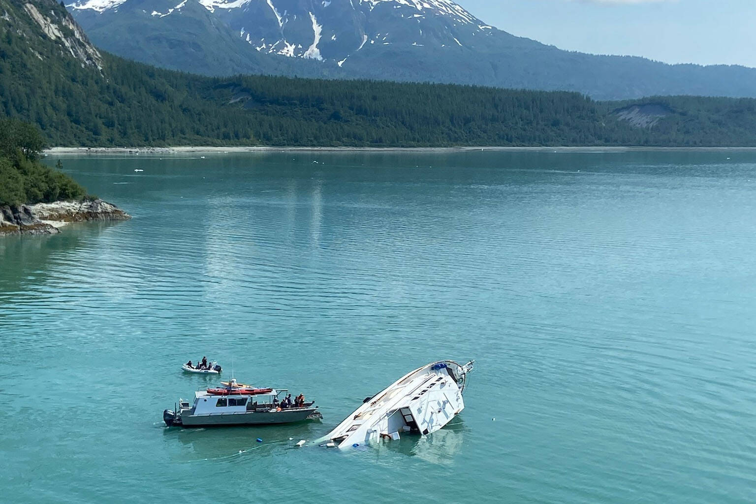 A Coast Guard aircrew and a Good Samaritan vessel rescued four mariners after their boat capsized in Glacier Bay National Park, Alaska, July 1, 2022. (Courtesy photo / USCG)