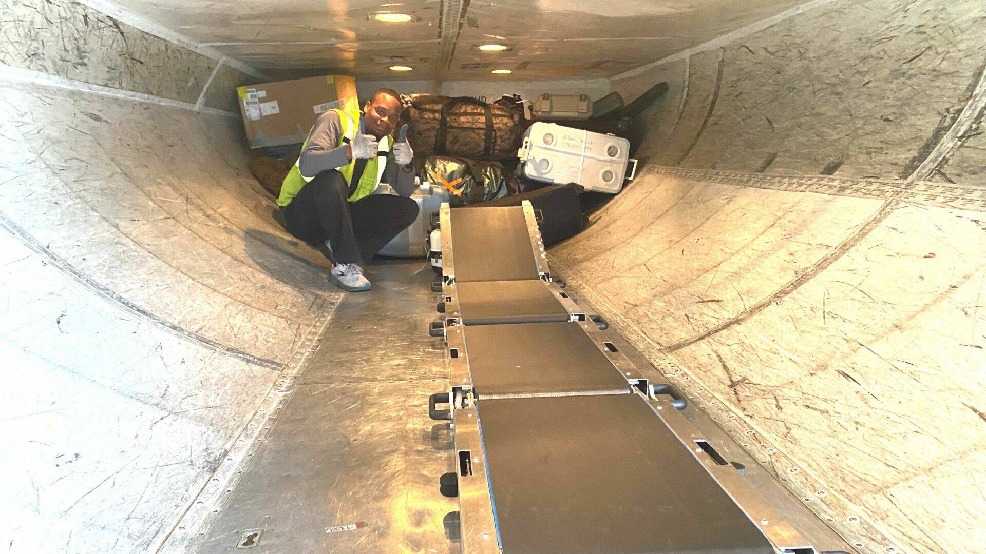 Happy ramp agent featured in good spirits as Fulton’s TISABAS does the labor intensive part of loading the aircraft. (Courtesy photo / Ramper Innovations)