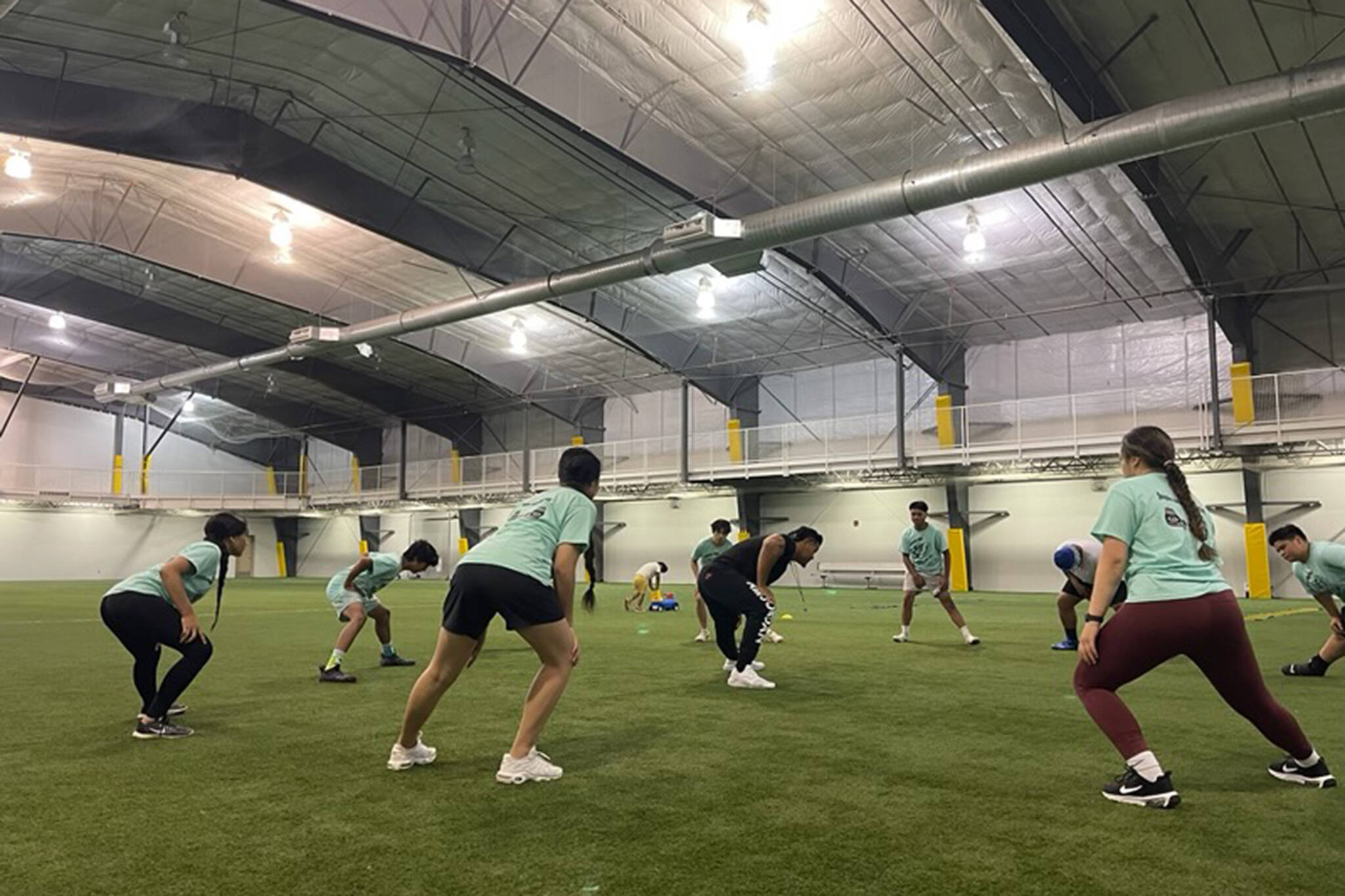 Former NFL defensive tackle leads an exercise inside the Dimond Park Field House. The former pro has been helping local athletes refine their skills while in town. (Courtesy Photo)