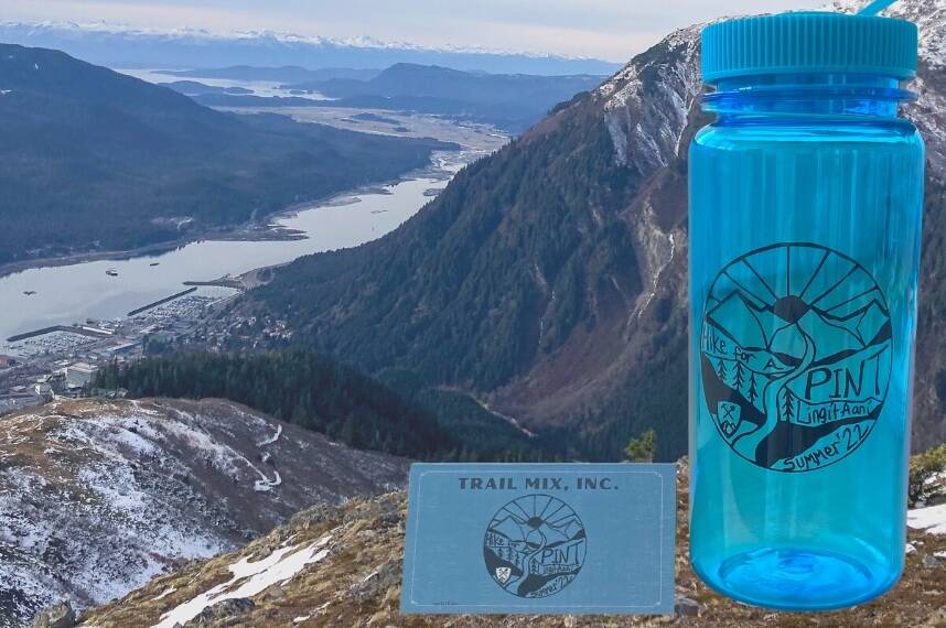 Mountain view from Mt. Roberts featuring Hike for a Pint passport and water bottle for this summer's event. (Courtesy photo / Meghan Tabcek)