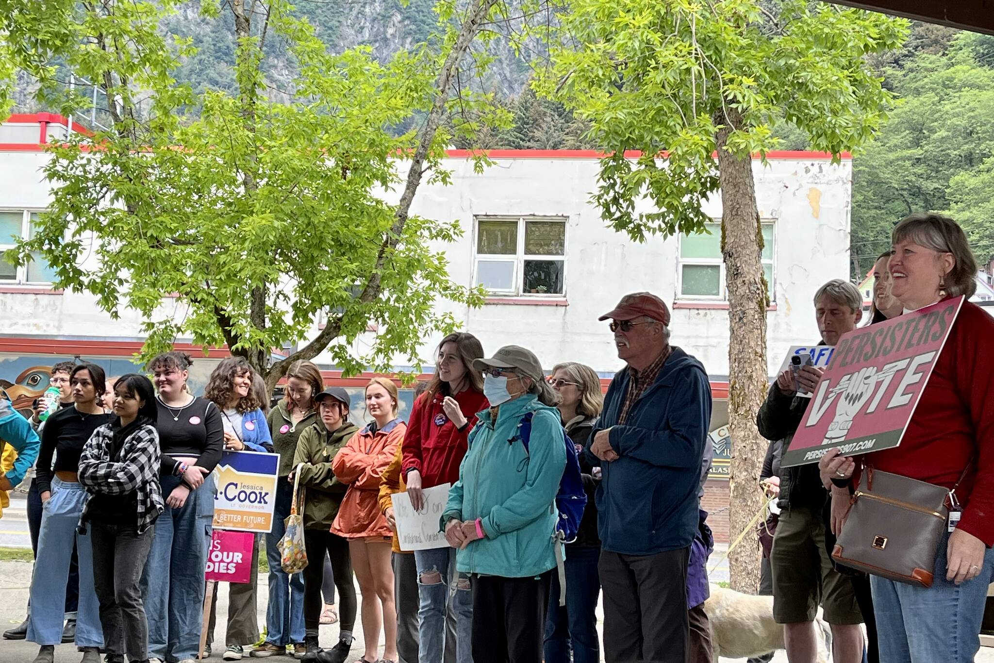 People gathered at rally listening to key note speakers with signs proudly displayed in support of pro-abortion rights. (Jonson Kuhn / Juneau Empire)