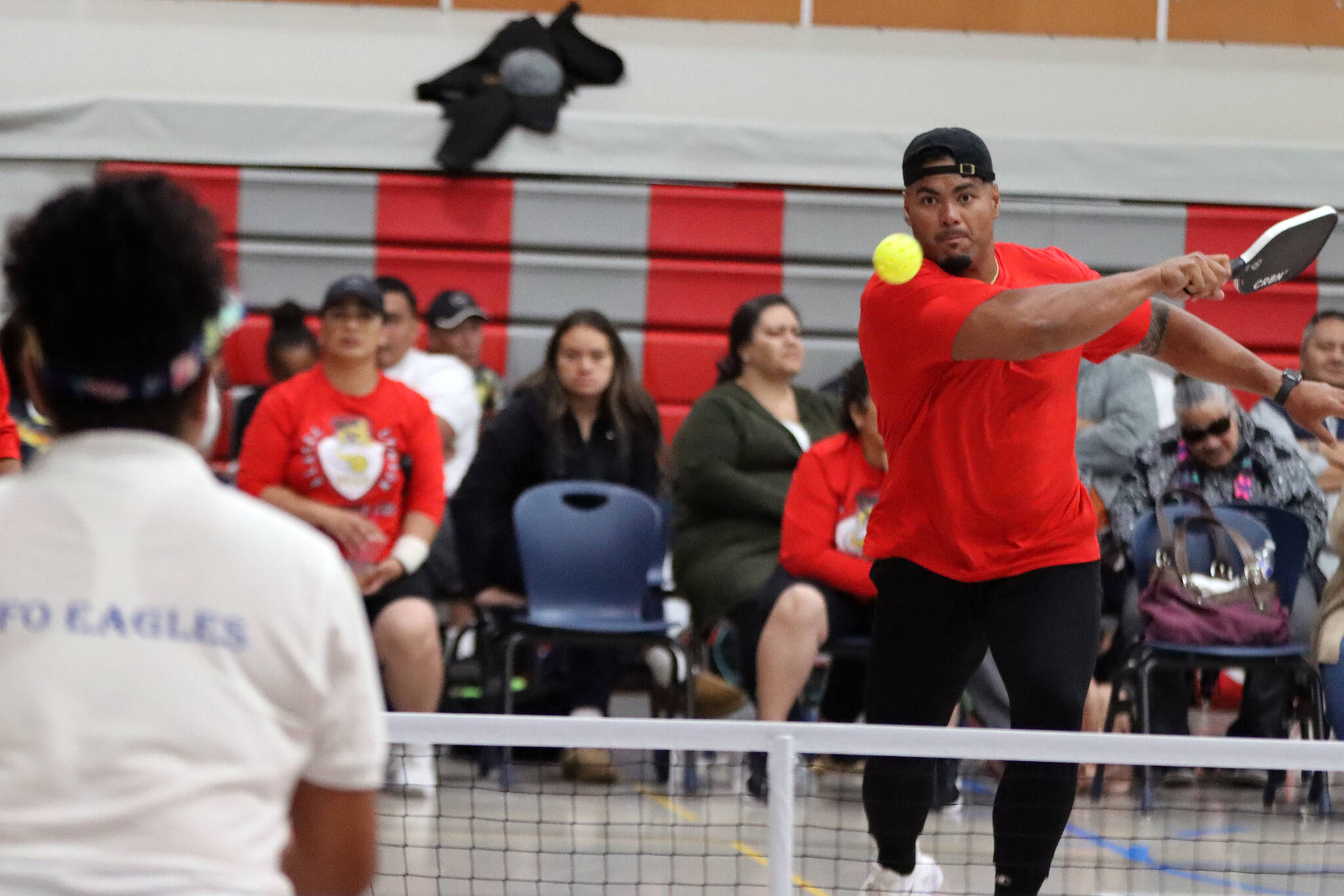 Stephen Paea sends a pickleball over the net Saturday at Floyd Dryden Middle School. Paea and wife, Vika Toetuu Paea, claimed the top spot in the tournament’s advanced mixed division. (Ben Hohenstatt / Juneau Empire)