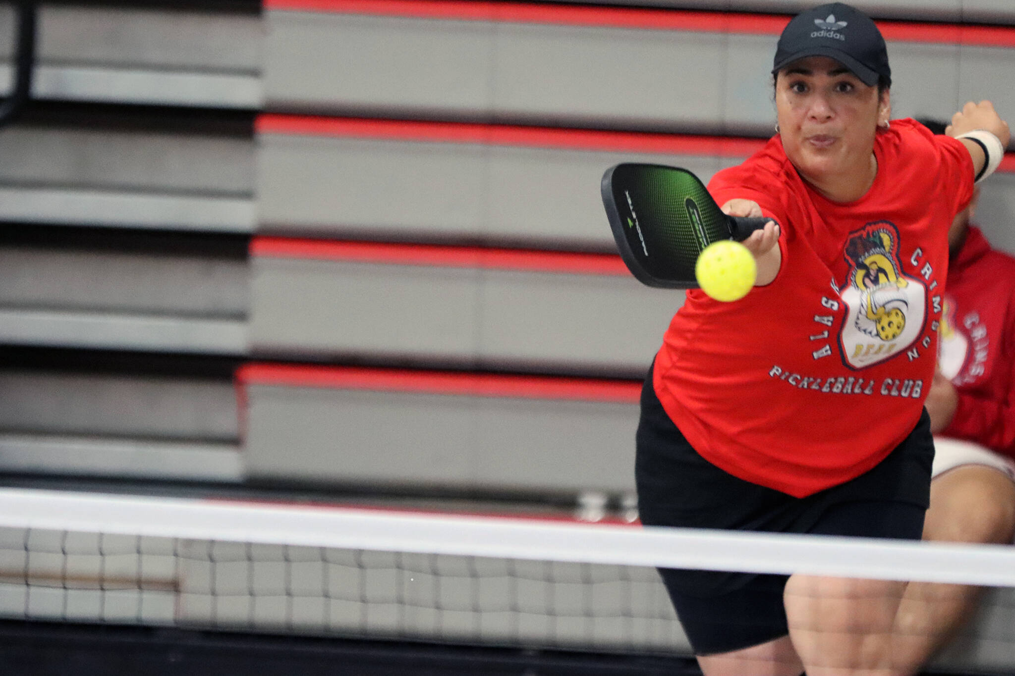 Mele Maake extends to reach a pickleball during the intermediate mixed bracket championship Saturday at Floyd Dryden Middle School. Maake, a member of the Alaska Crimson Bear Pickleball Club, was one half of two first-place teams. (Ben Hohenstatt / Juneau Empire)