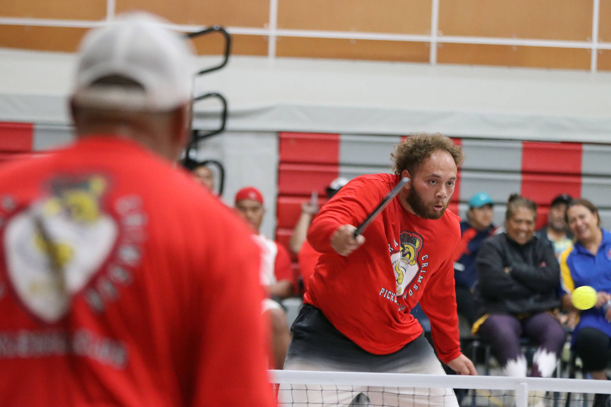 Vaipuna Toutaiolepo returns a pickleball over the net Saturday afternoon at Floyd Dryden Middle School. Toutaiolepo, a member of the Alaska Crimson Bear Pickleball Club, was among dozens of players to participate in a tournament. (Ben Hohenstatt / Juneau Empire)