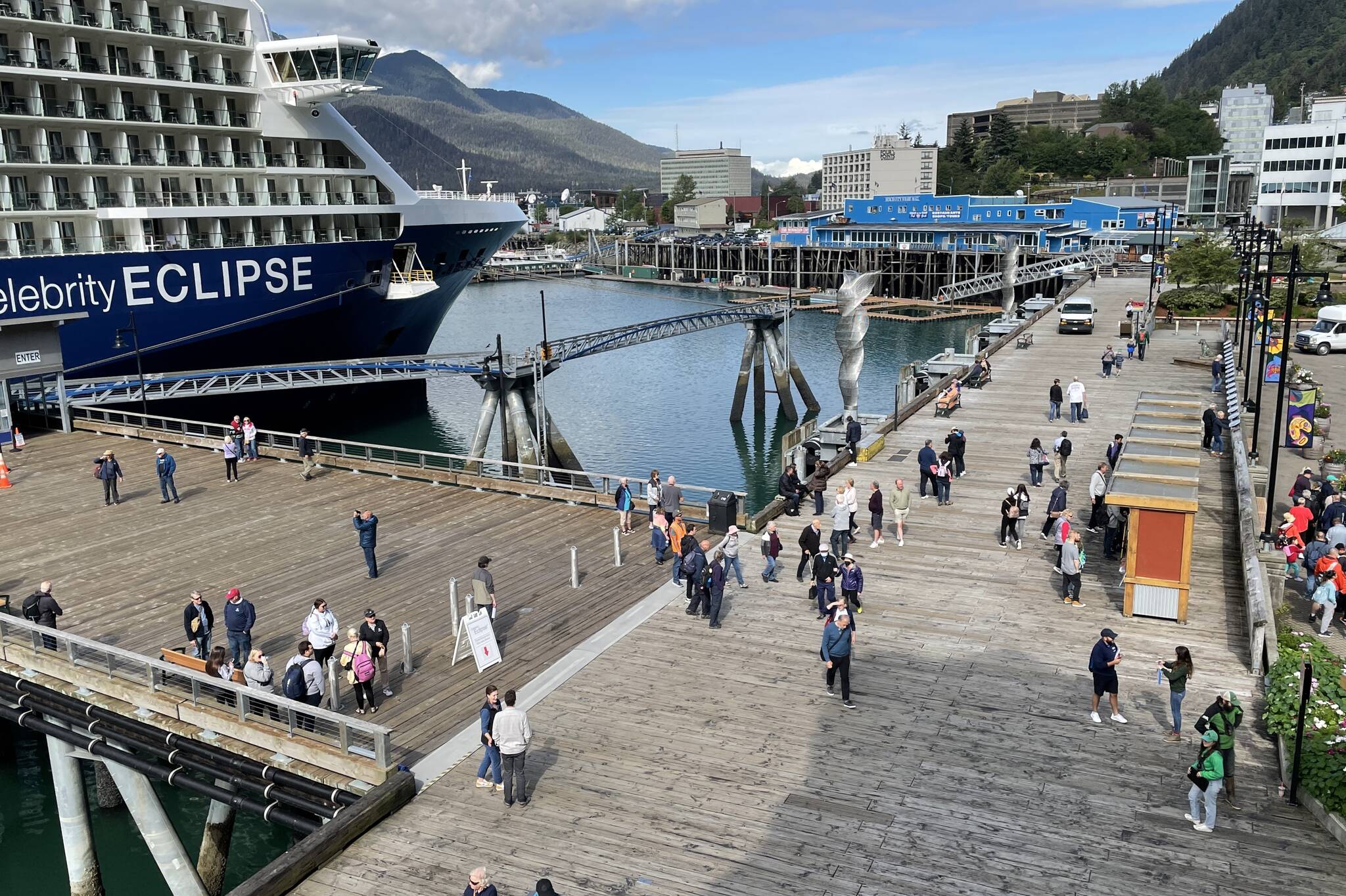 Tourists walk the piers downtown on July 14, 2022. (Michael S. Lockett / Juneau Empire)