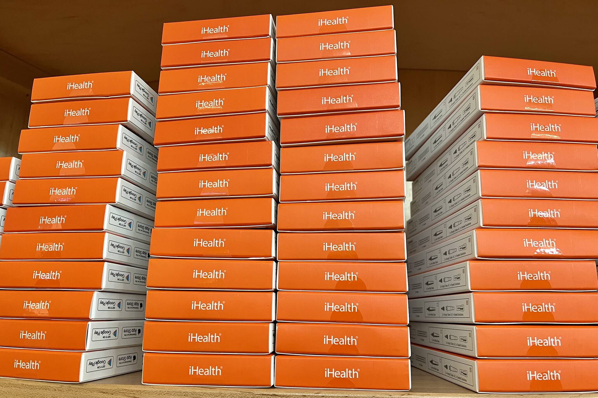 Newly stocked supply of rapid antigen self-tests ate stacked at the Mendenhall Valley Library and are available at all public libraries throughout Juneau and other locations, as well. (Jonson Kuhn / Juneau Empire)