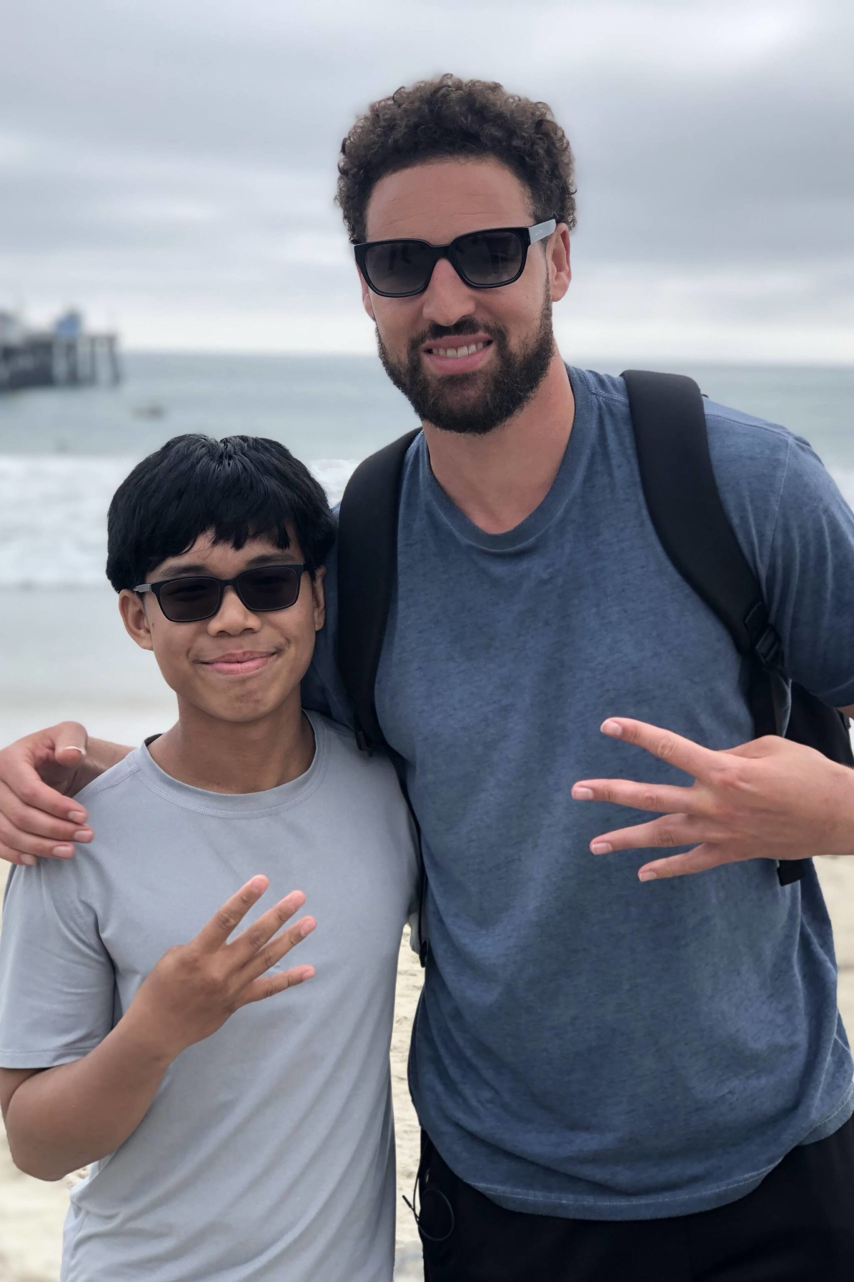 Joseph Tagaban and Klay Thompson hold up four fingers to represent Thompson’s four championships won with the Golden State Warriors. (Courtesy photo / Tagaban family)