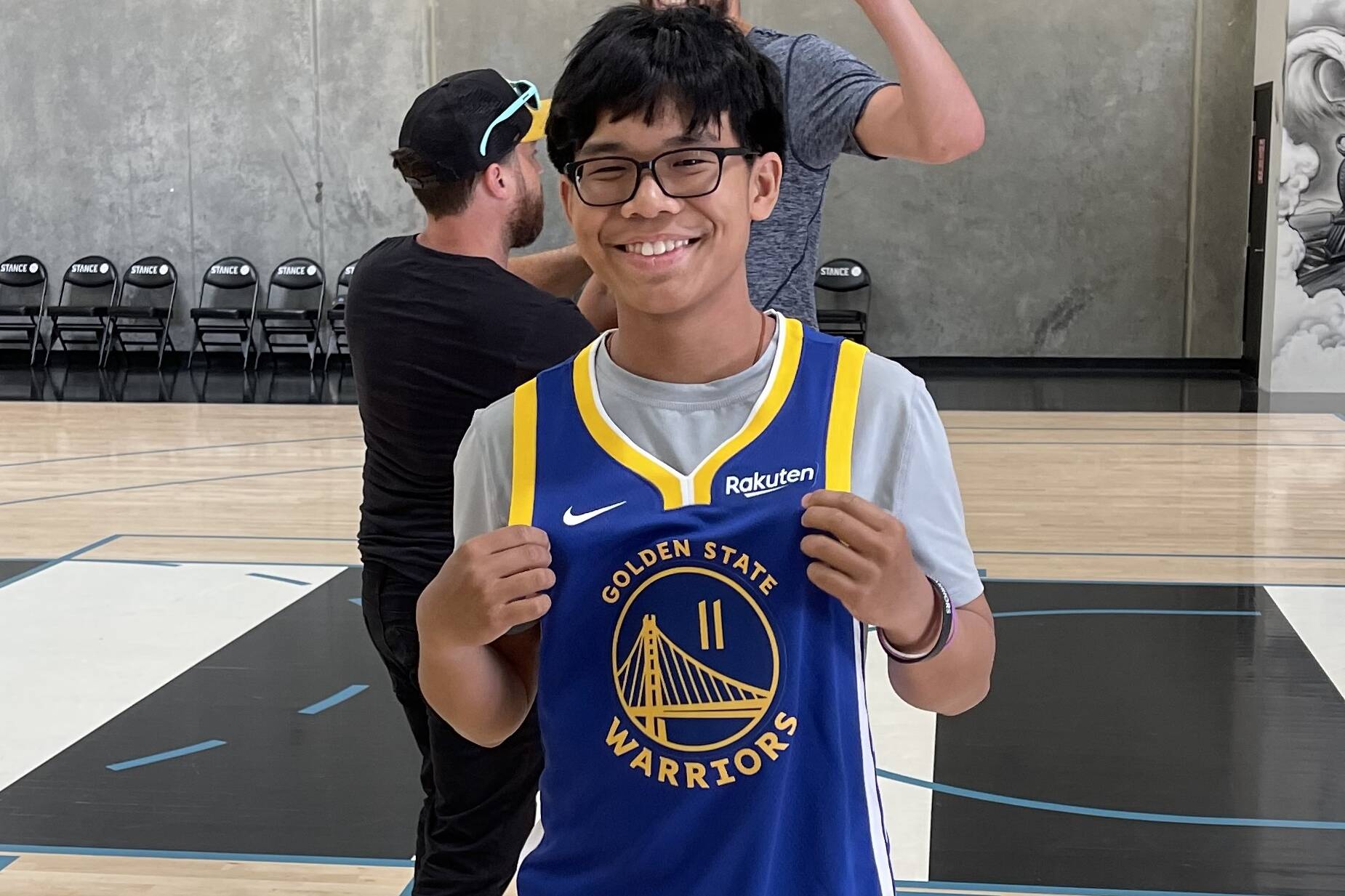 Joseph Tagaban poses with a newly signed Golden State Warriors jersey after spending the day with his NBA idol Klay Thompson, whose given him inspiration through his battle with cancer. (Courtesy photo / Tagaban family)