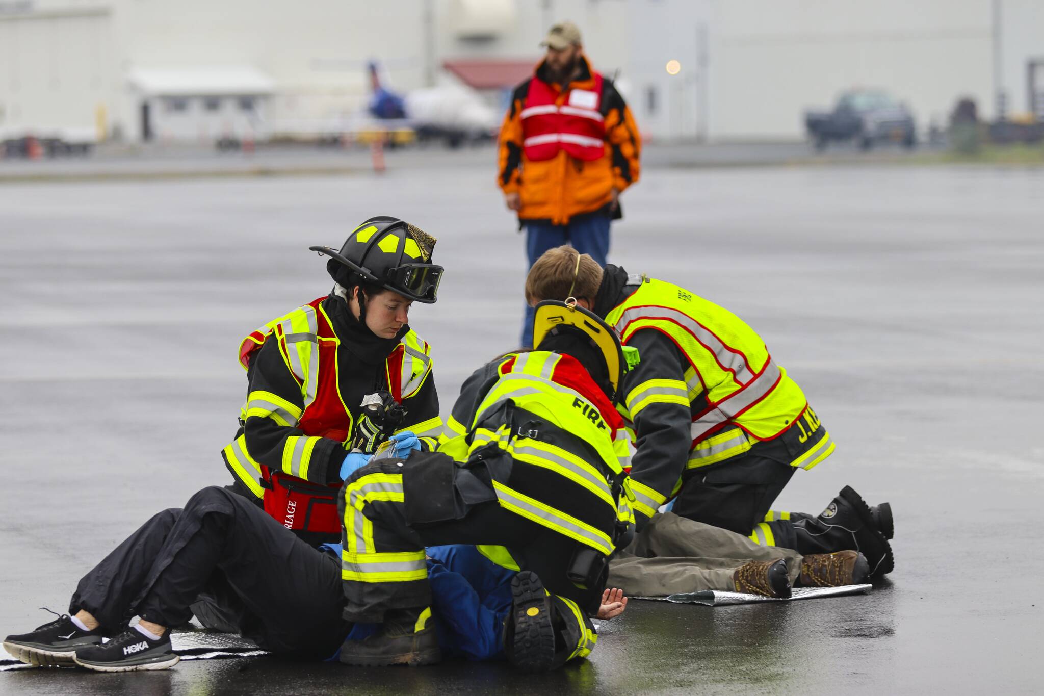 Capital City Fire/Rescue personnel triage a casualty during an exercise simulating a plane crash at Juneau International Airport on July 23, 2022. (Michael S. Lockett / Juneau Empire)