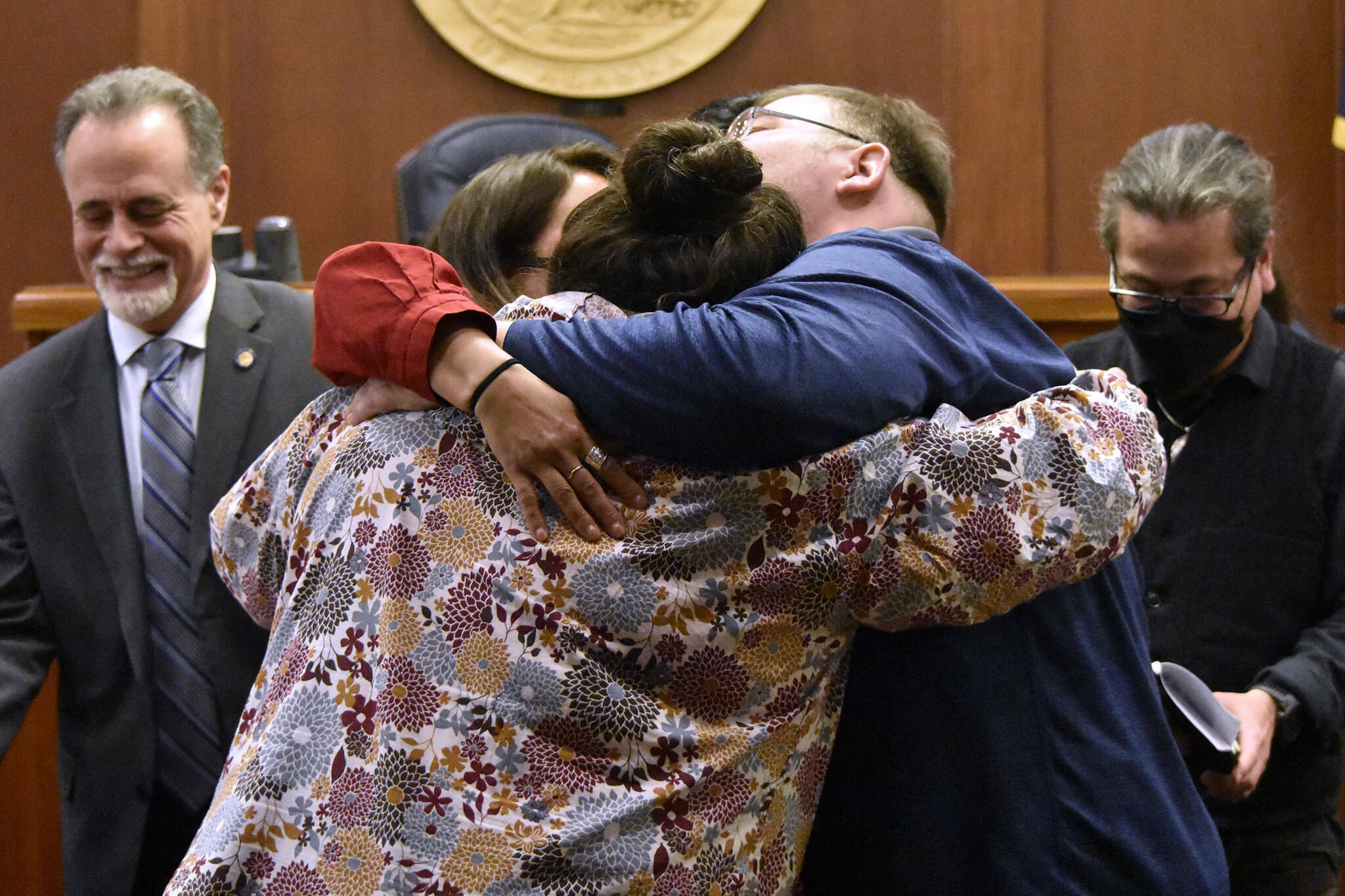 Alaskans for Better Government members La quen náay Liz Medicine Crow, Richard Chalyee Éesh Peterson and ‘Wáahlaal Gidáak Barbara Blake embrace on the floor of the Alaska State Senate on Friday, May 13, 2022, following the passage of House Bill 123, a bill to formally recognize the state's 229 already federally-recognized tribes. Gov. Mike Dunleavy is scheduled to sign the bill during a ceremony Thursday during a ceremony in Anchorage. (Peter Segall / Juneau Empire)