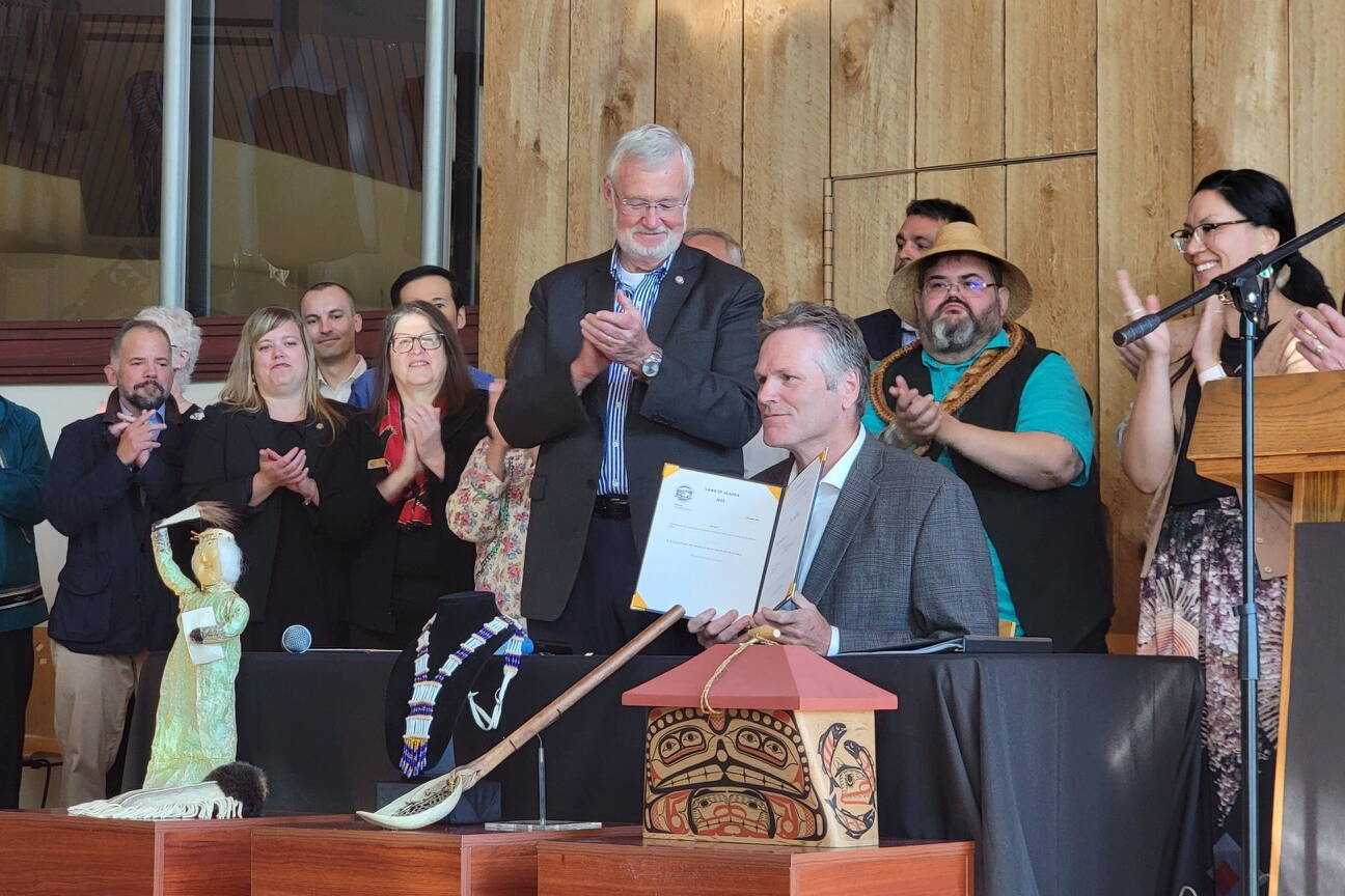 Alaska Gov. Mike Dunleavy holds up a bill providing state recognition of the 229 federally recognized Alaska Native tribes after signing it Thursday during a ceremony at the Alaska Native Heritage Center in Anchorage. He also signed a bill authorizing tribes to establish compact schools under a pilot program. (Courtesy Photo / Alaska Federation of Natives)