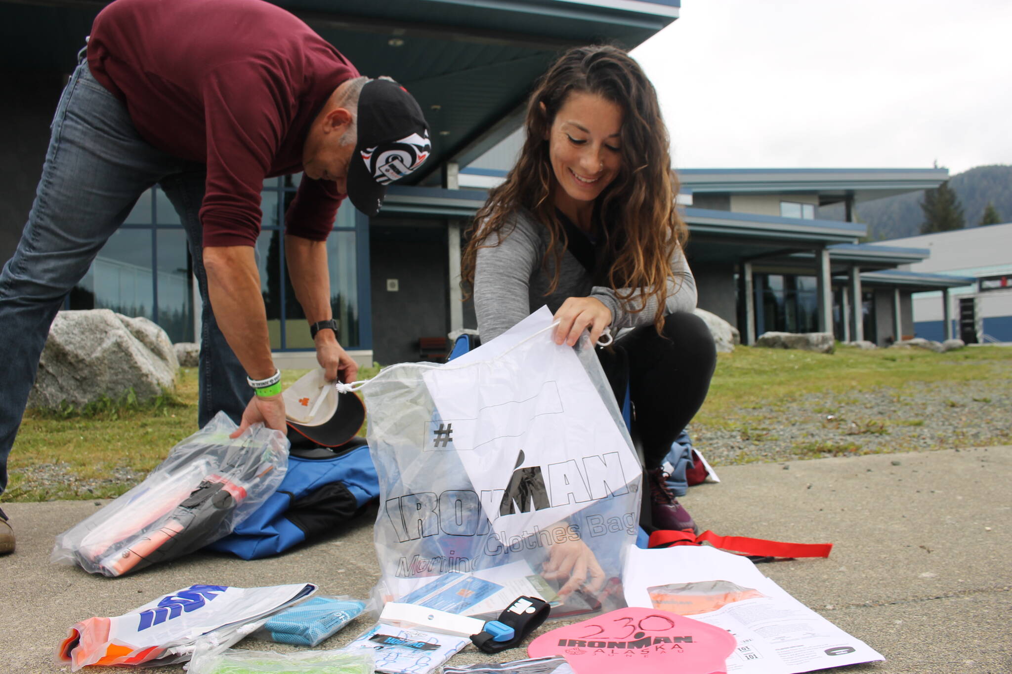 Genna Boragine shows off all her Ironman swag outside of the Ironman Village at Thunder Mountain High School. Racers and volunteers filled the high school as they registered and explored the expo. (Clarise Larson / Juneau Empire)