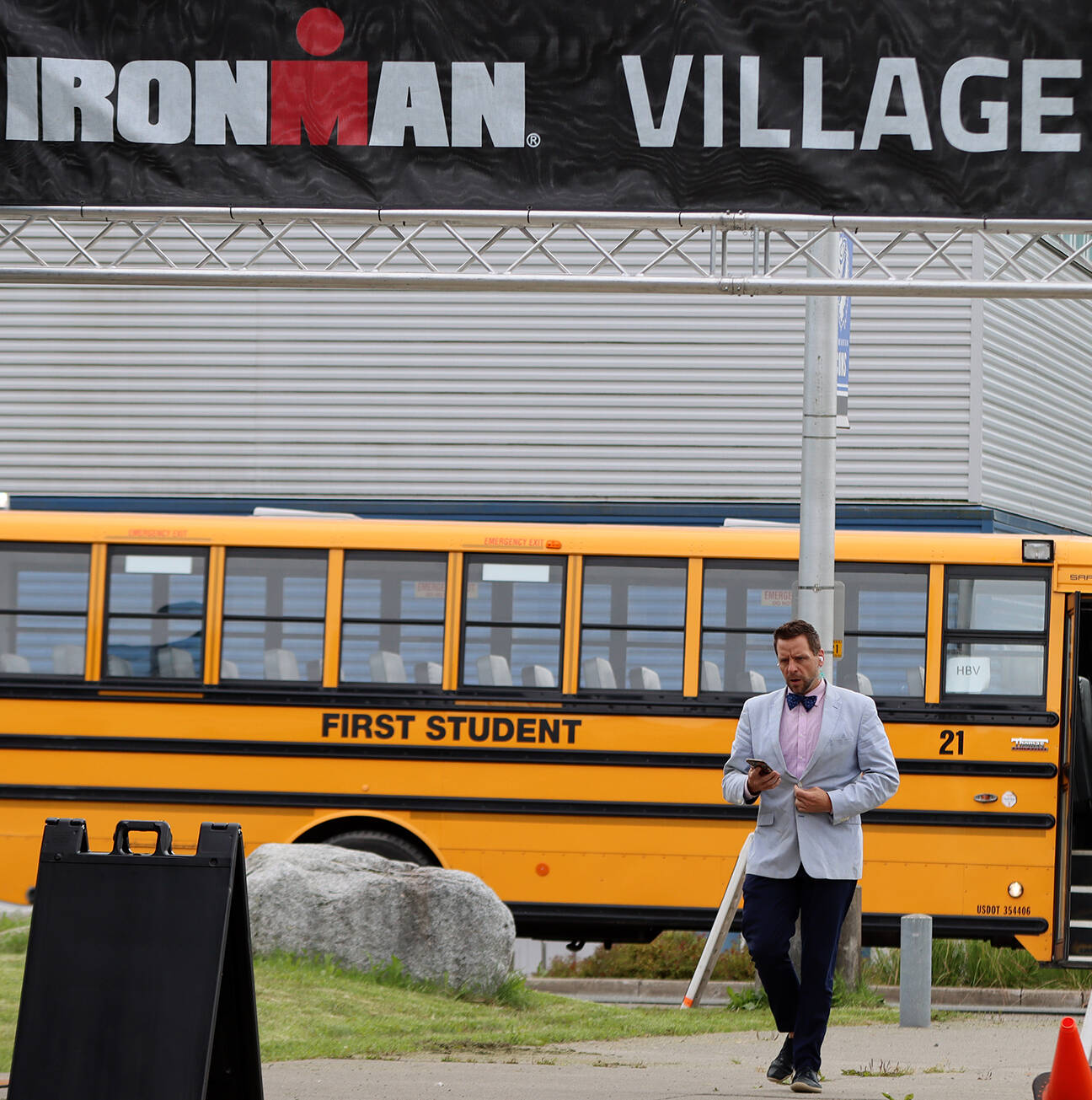 Jeff Rogers, the City and Borough of Juneau’s financial director, heads to the Ironman Village at Thunder Mountain High School on Thursday afternoon to attend the athlete briefing event. (Ben Hohenstatt / Juneau Empire)
