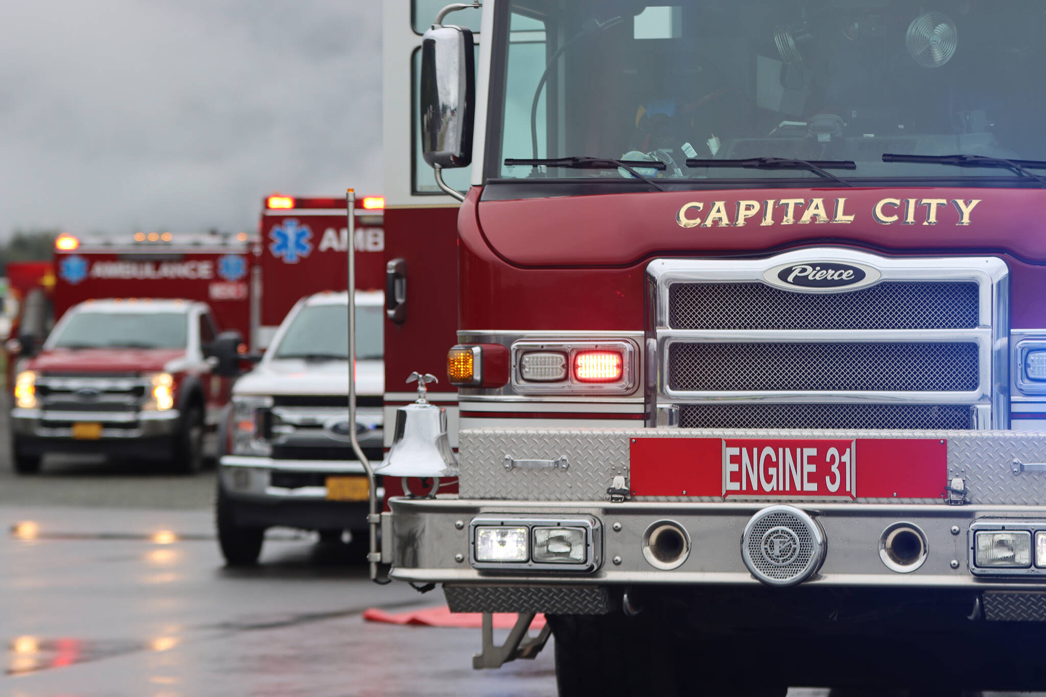 Capital City Fire/Rescue vehicles form a line at Juneau International Airport for a drill. (Ben Hohenstatt / Juneau Empire File)