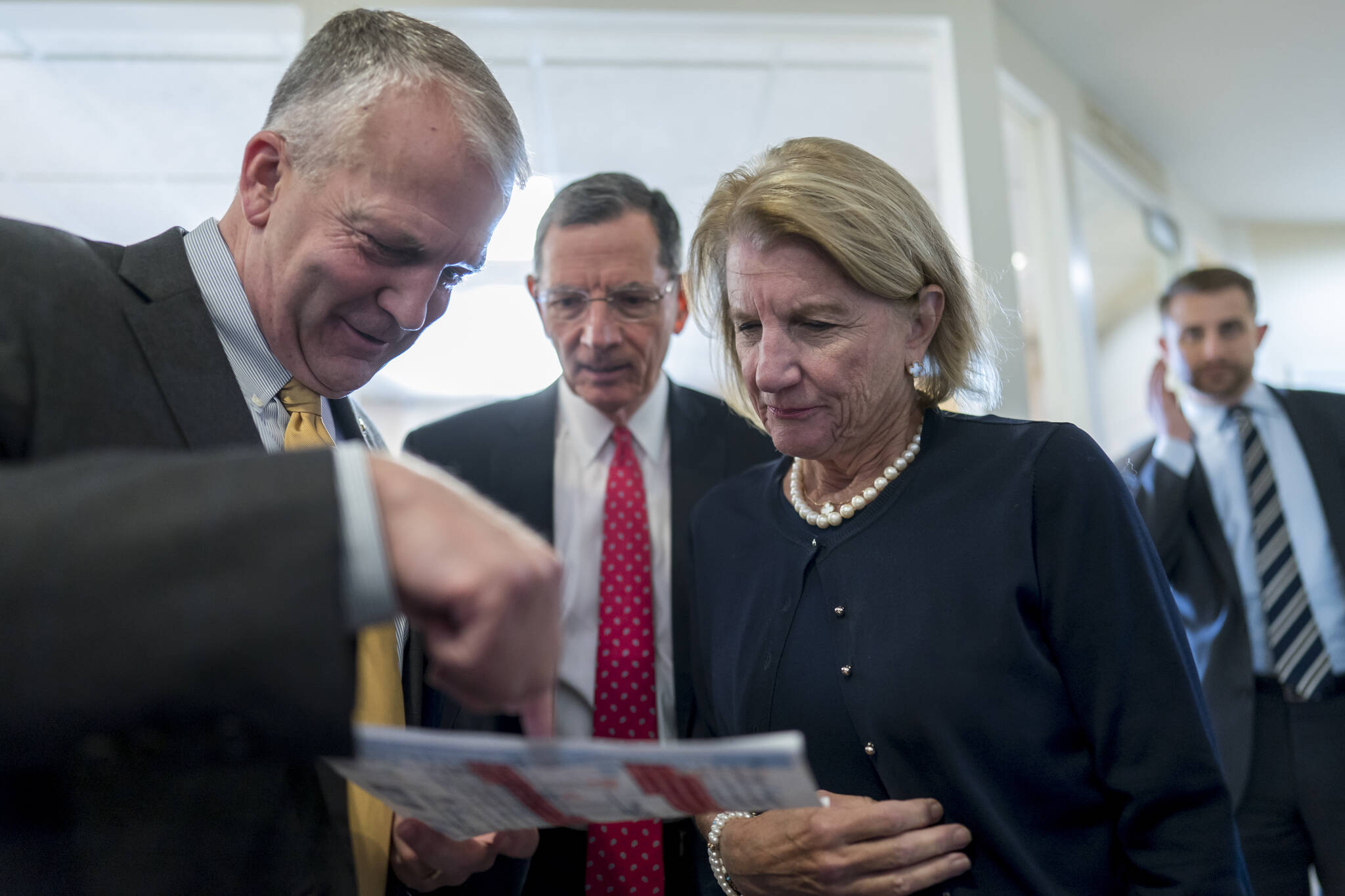 From left, Sen. Dan Sullivan, R-Alaska, Sen. John Barrasso, R-Wyo., and Sen. Shelley Moore Capito, R-W.Va., confer just before a news conference to discuss their efforts to rescind recent Biden administration rules on the National Environmental Policy Act, at the Capitol in Washington, Tuesday, Aug. 2, 2022. (AP Photo / J. Scott Applewhite)